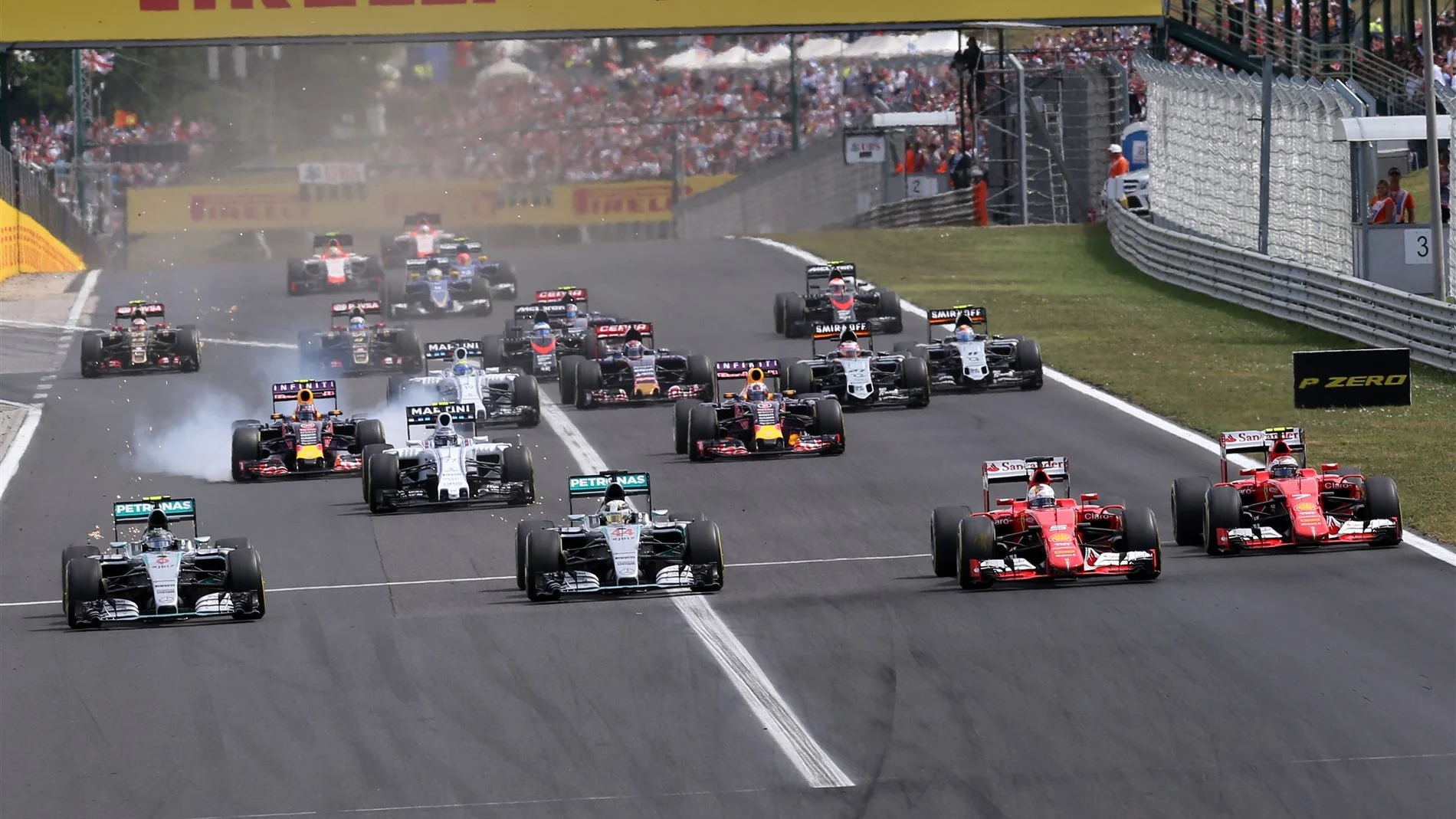 Nico Rosberg (GER) Mercedes AMG F1 W06, Lewis Hamilton (GBR) Mercedes AMG F1 W06, Sebastian Vettel (GER) Ferrari SF15-T and Kimi Raikkonen (FIN) Ferrari SF15-T at the start of the race at Formula One World Championship, Rd10, Hungarian Grand Prix, Race, Hungaroring, Hungary, Sunday 26 July 2015. © Sutton Motorsport Images
