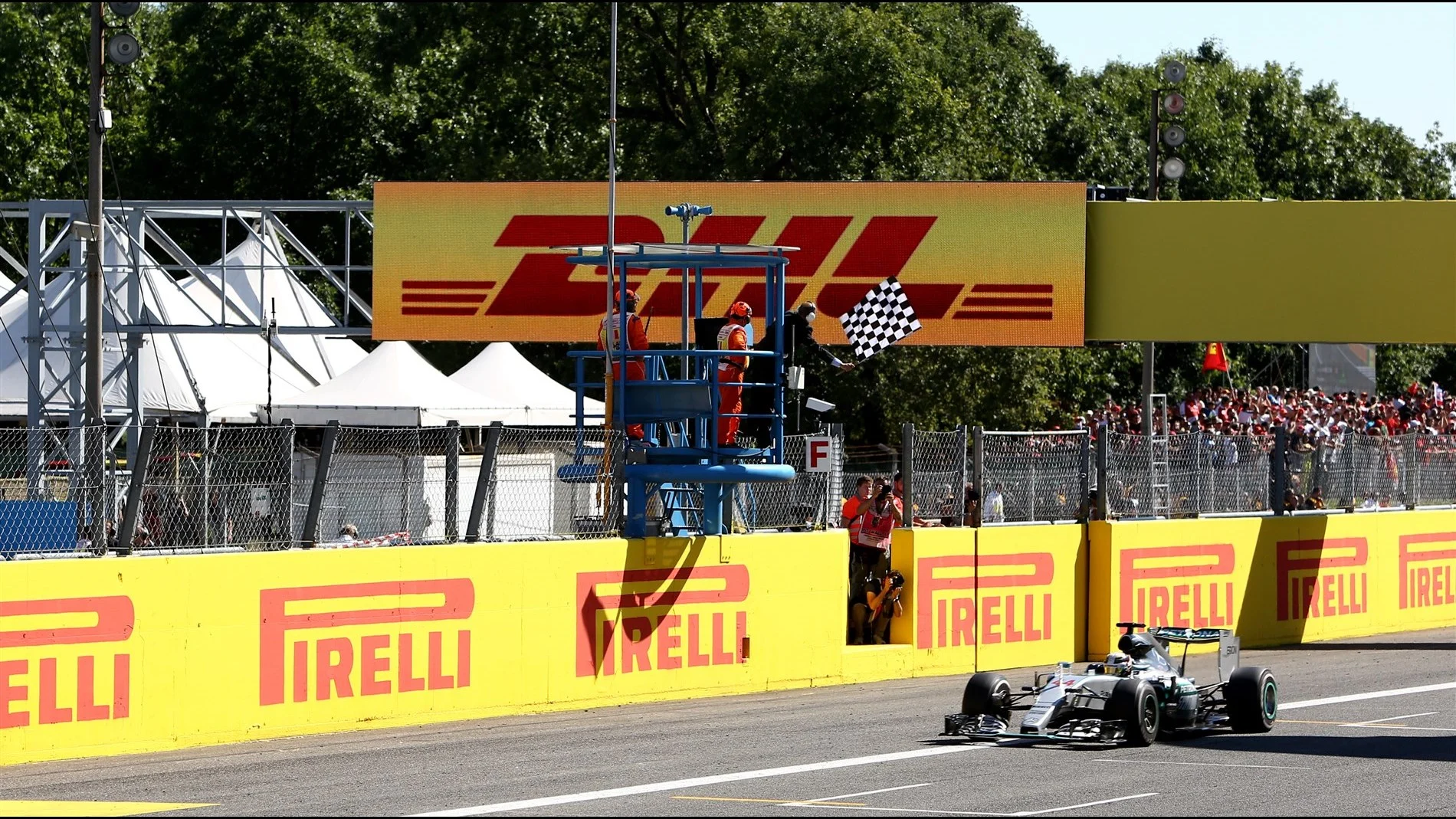 Lewis Hamilton (GBR) Mercedes AMG F1 W06 crosses the line to take the chequered flag at Formula One