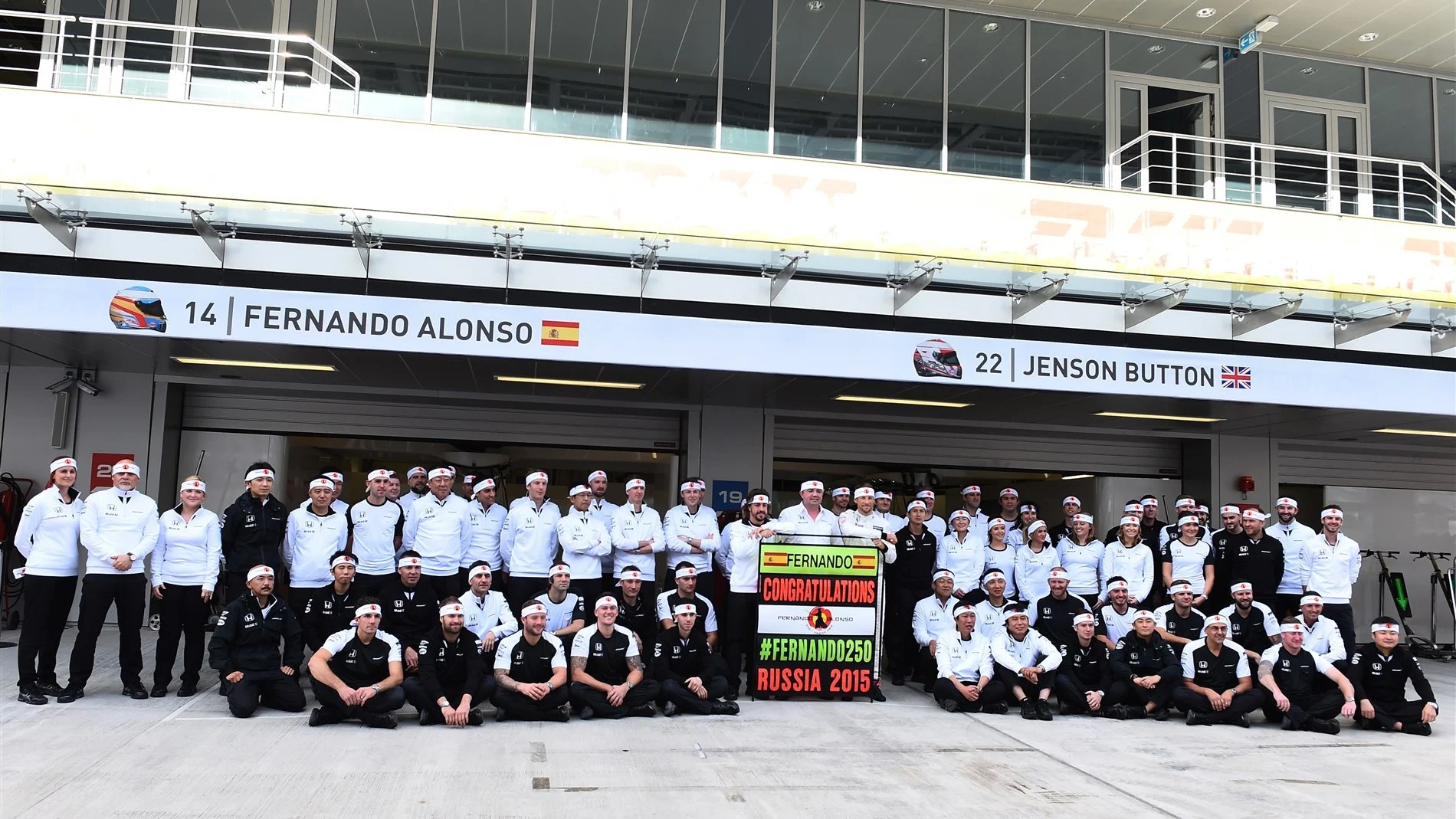 Fernando Alonso (ESP) McLaren celebrates 250 Grands Prix with Eric Boullier (FRA) McLaren Racing Director, Jenson Button (GBR) McLaren and the team at Formula One World Championship, Rd15, Russian Grand Prix, Practice, Sochi Autodrom, Sochi, Krasnodar Krai, Russia, Friday 9 October 2015. © Sutton Motorsport Images