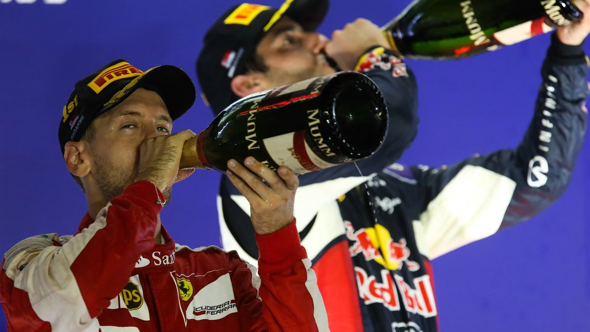 Race winner Sebastian Vettel (GER) Ferrari and Daniel Ricciardo (AUS) Red Bull Racing celebrate on the podium with champagne at Formula One World Championship, Rd13, Singapore Grand Prix, Race, Marina Bay Street Circuit, Singapore, Sunday 20 September 2015. © Sutton Motorsport Images