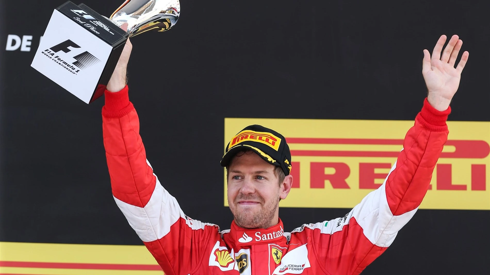 Sebastian Vettel (GER) Ferrari celebrates with his trophy on the podium at Formula One World