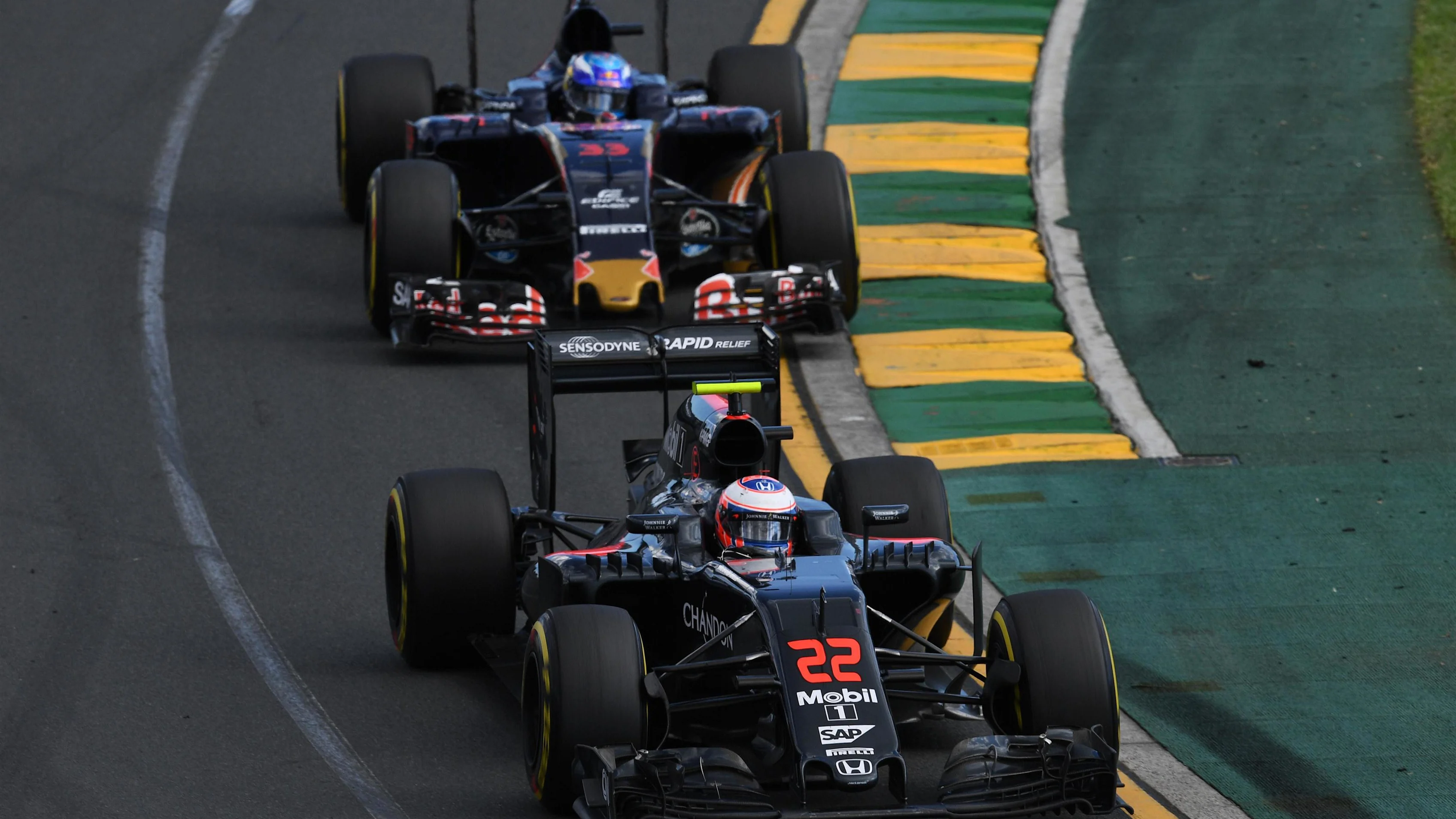 Jenson Button (GBR) McLaren MP4-31 and Max Verstappen (NED) Scuderia Toro Rosso STR11 at Formula