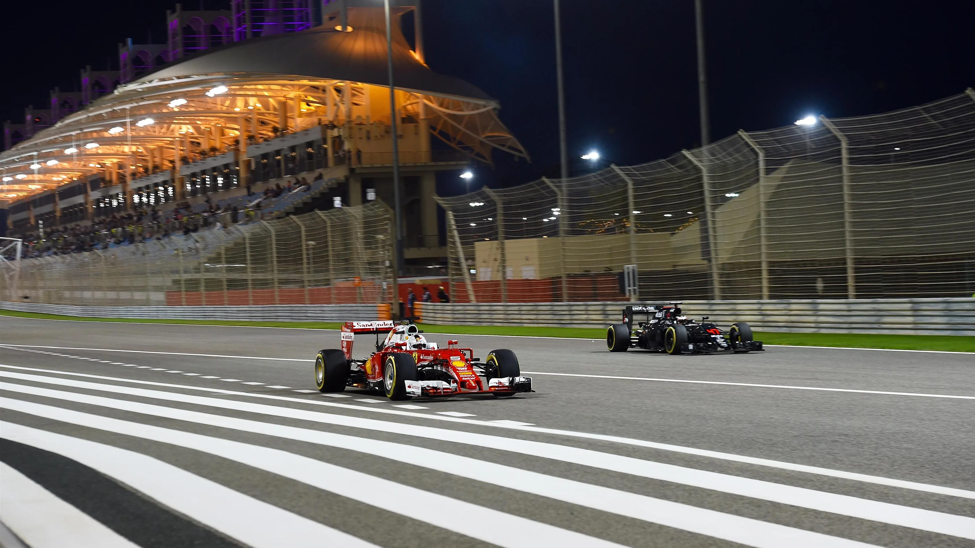 Sebastian Vettel (GER) Ferrari SF16-H and Stoffel Vandoorne (BEL) McLaren MP4-31 at Formula One