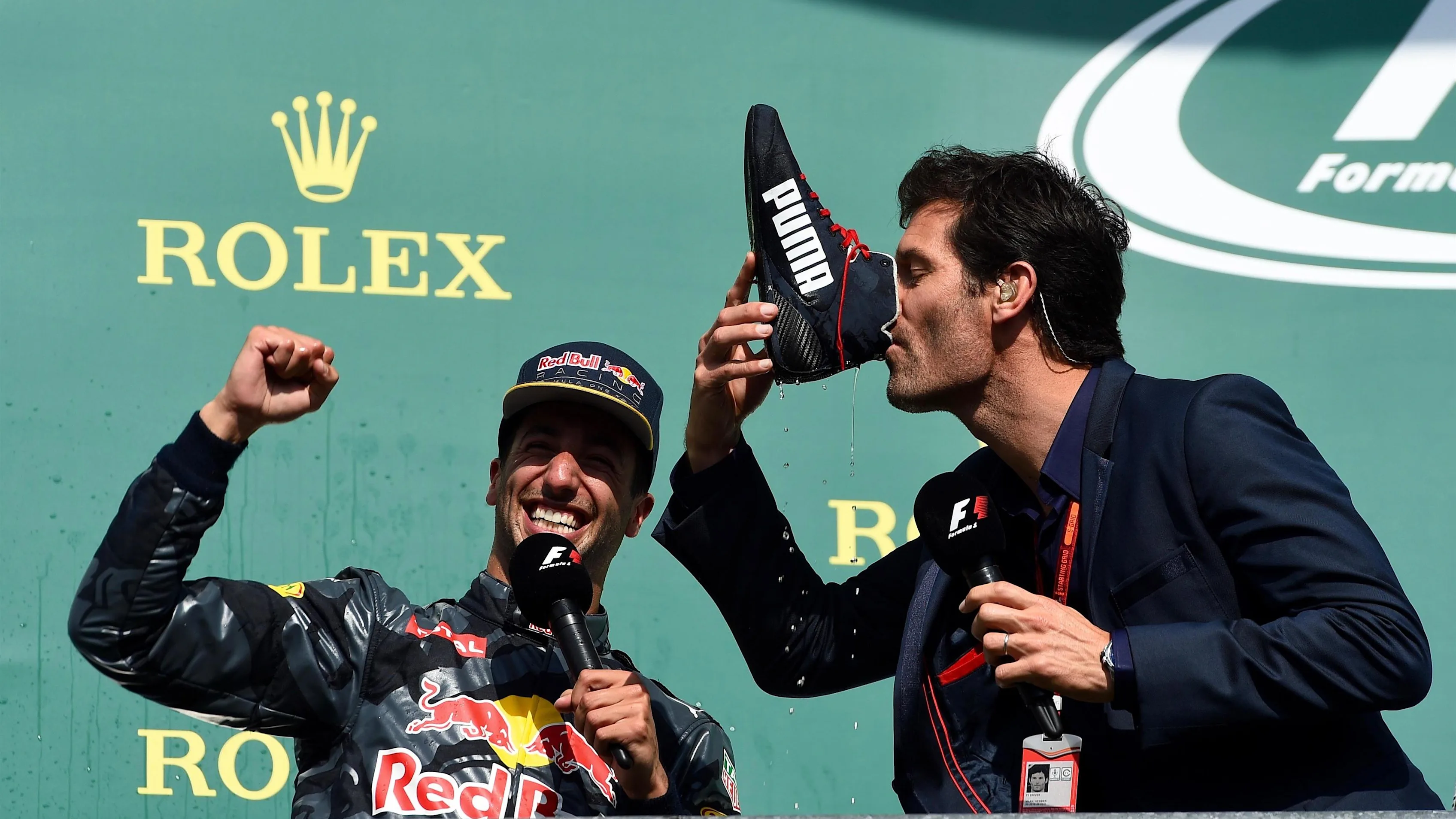 Daniel Ricciardo (AUS) Red Bull Racing celebrates on the podium and Mark Webber (AUS) drinks