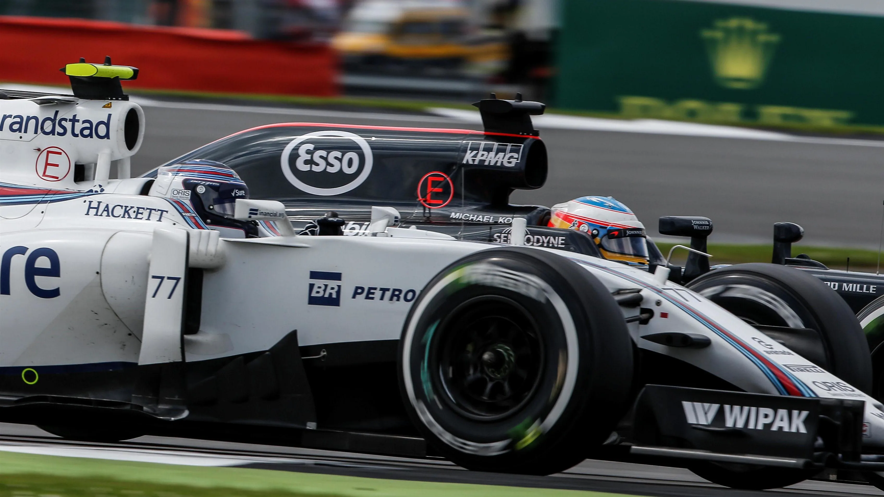 Valtteri Bottas (FIN) Williams FW38 and Fernando Alonso (ESP) McLaren MP4-31 battle at Formula One