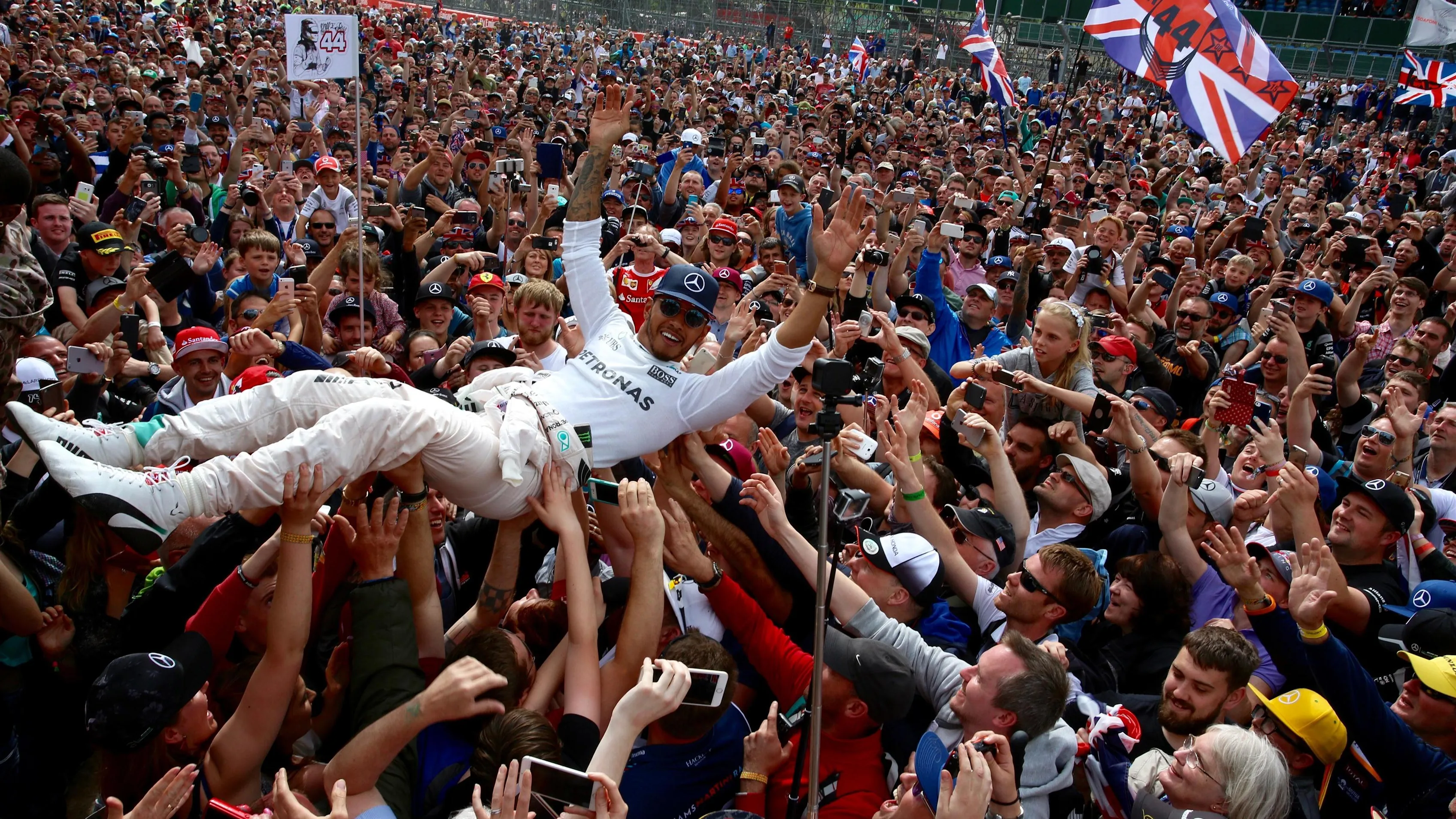 Race winner celebrates with the fans by crowdsurfing at Formula One World Championship, Rd10,