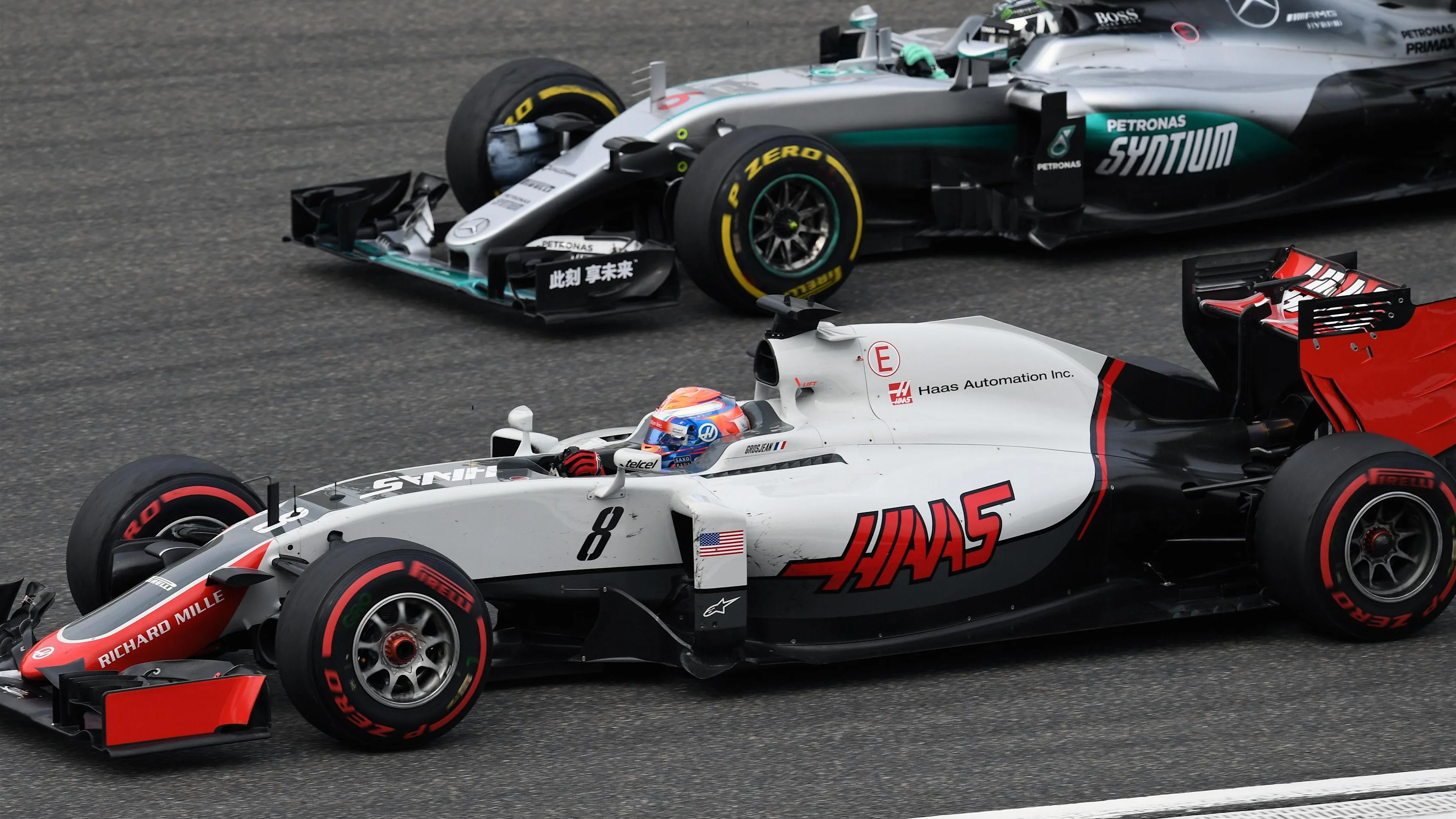 Romain Grosjean (FRA) Haas VF-16 and Nico Rosberg (GER) Mercedes-Benz F1 W07 Hybrid battle at