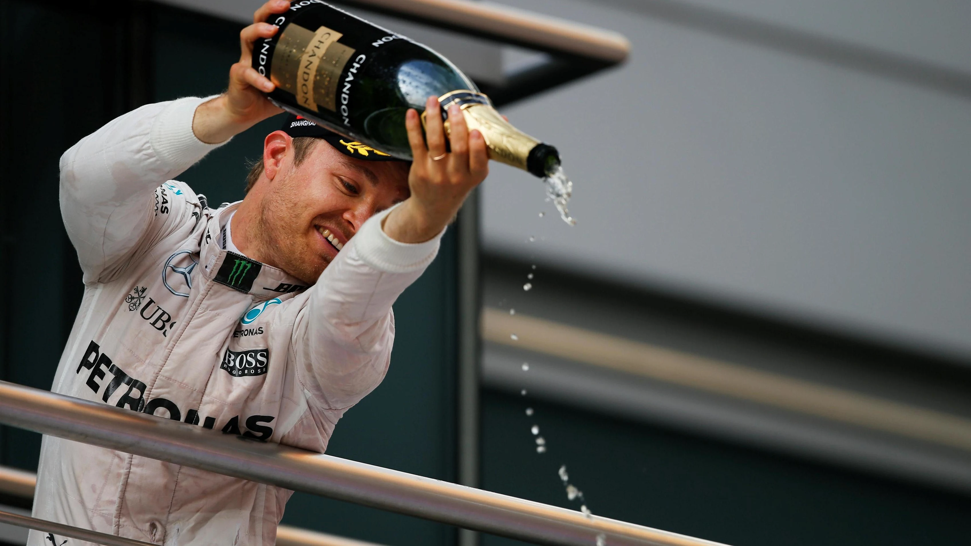 Race winner Nico Rosberg (GER) Mercedes AMG F1 celebrates on the podium with the campagne at