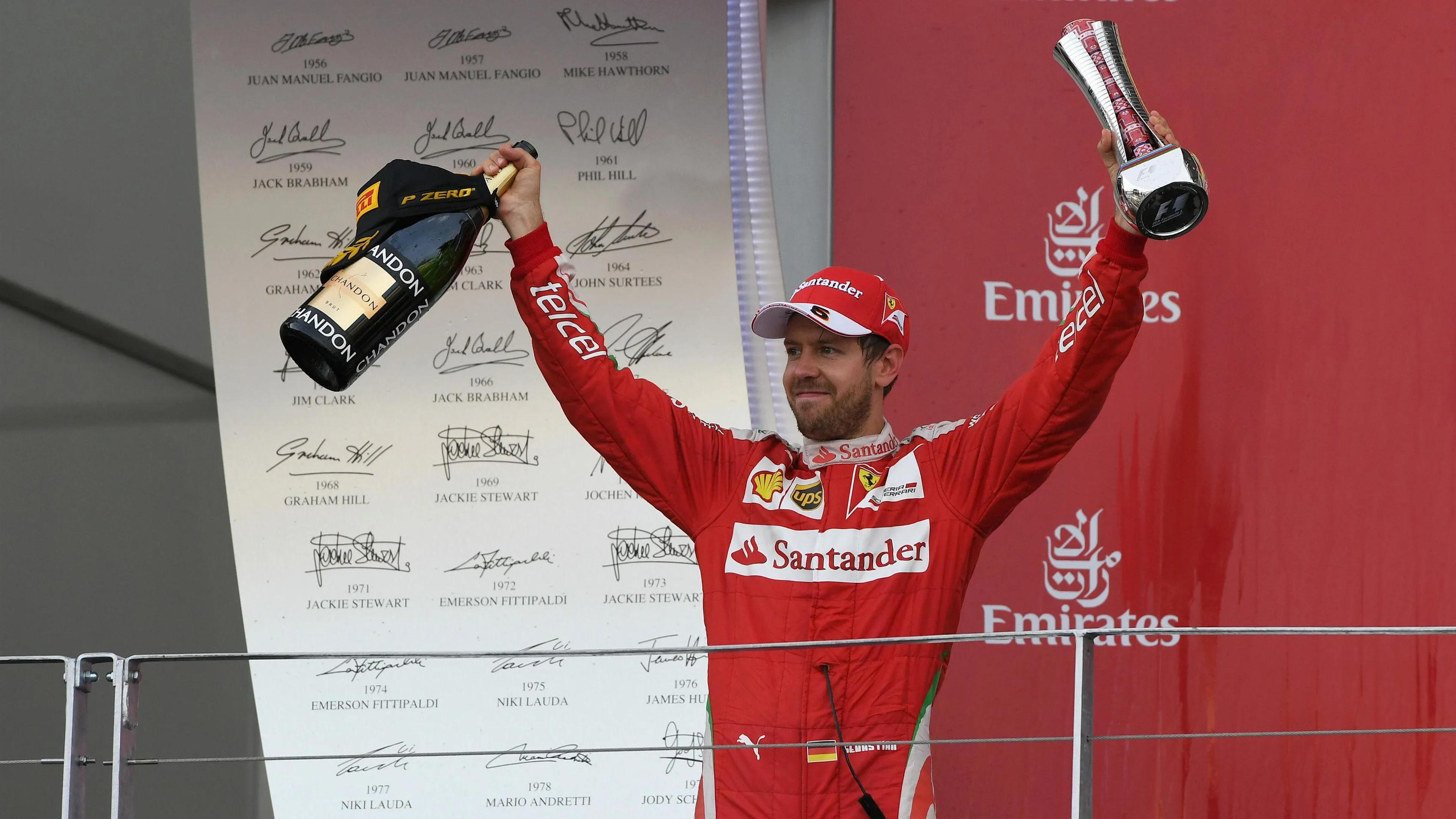 Sebastian Vettel (GER) Ferrari celebrates on the podium with the champagne and the trophy at
