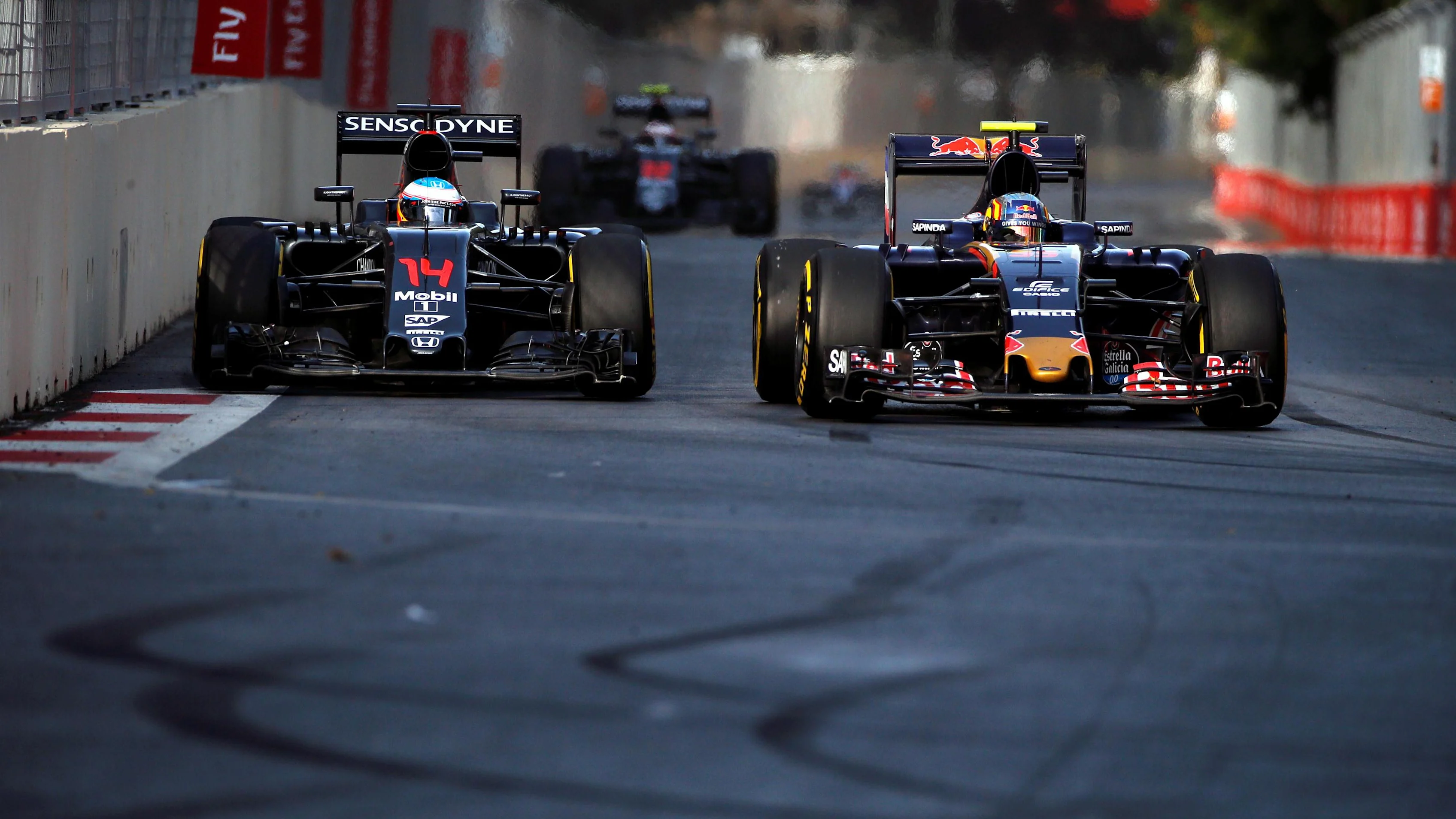 Fernando Alonso (ESP) McLaren MP4-31 and Carlos Sainz jr (ESP) Scuderia Toro Rosso STR11 battle for position at the start of the race at Formula One World Championship, Rd8, European Grand Prix, Race, Baku City Circuit, Baku, Azerbaijan, Sunday 19 June 2016. © Sutton Images
