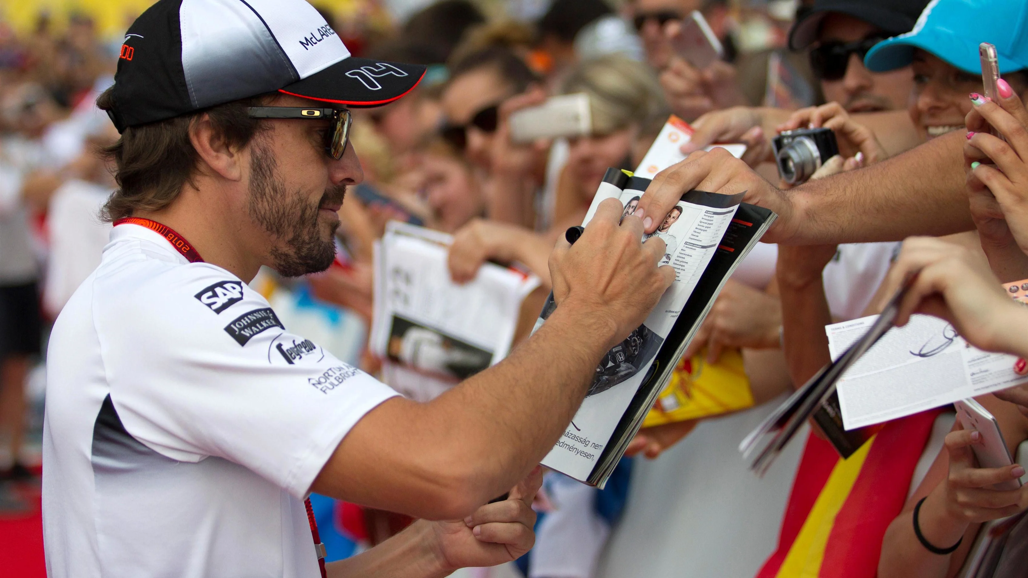 Fernando Alonso (ESP) McLaren signs autographs for the fans at Formula One World Championship,