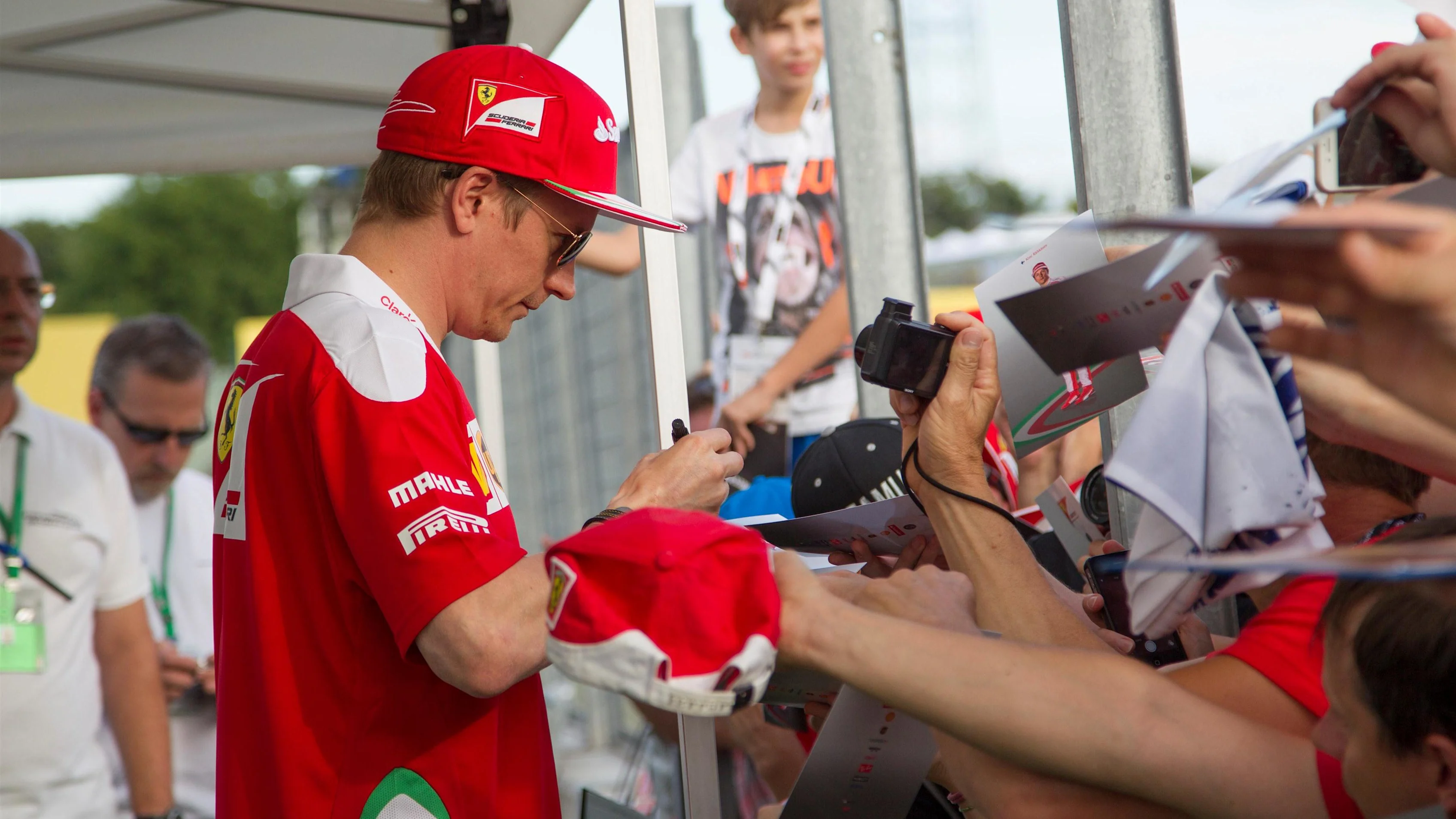 Kimi Raikkonen (FIN) Ferrari signs autographs for the fans at Formula One World Championship, Rd11,