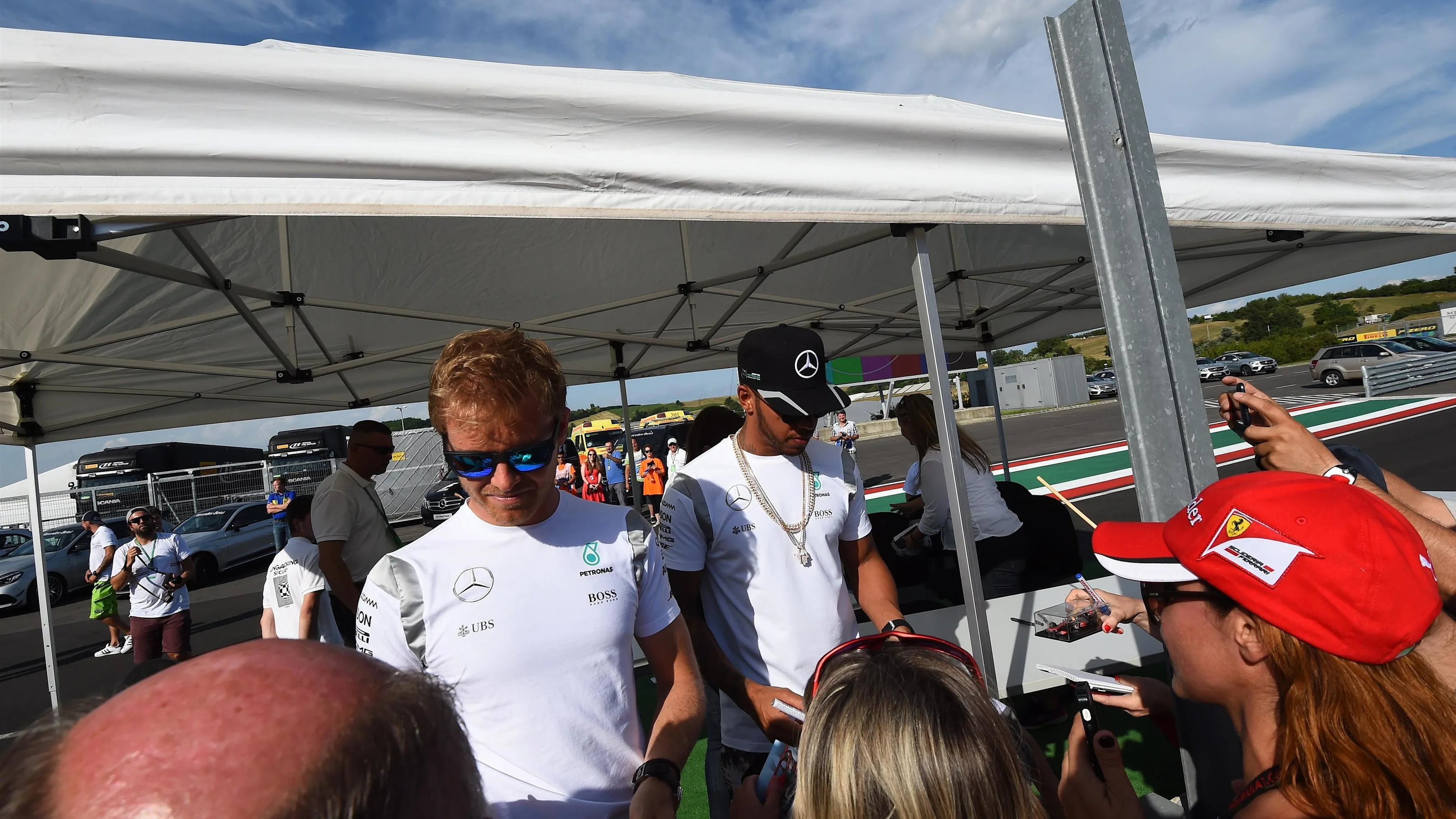 Nico Rosberg (GER) Mercedes AMG F1 and Lewis Hamilton (GBR) Mercedes AMG F1 sign autographs for the