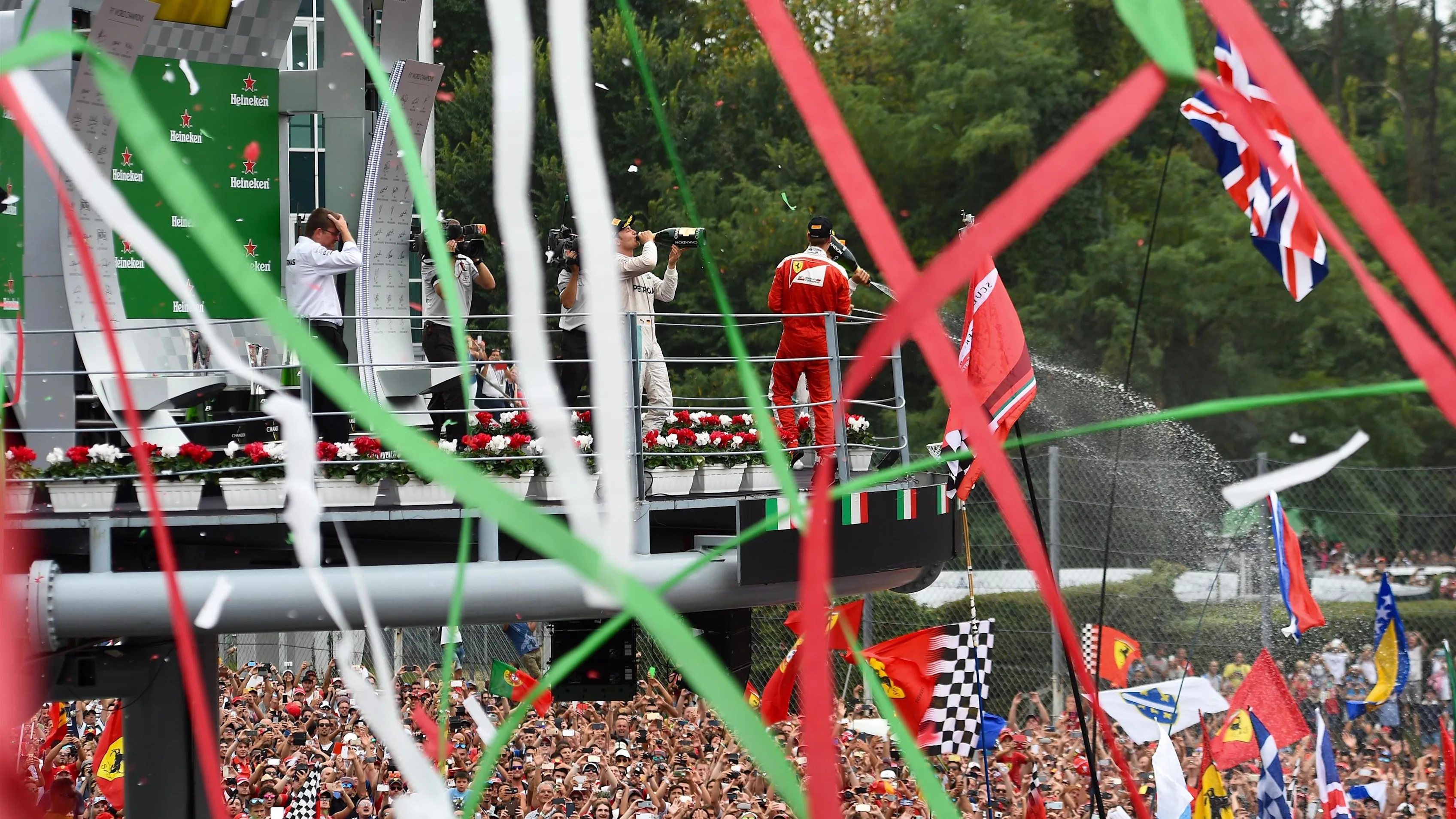Race winner Nico Rosberg (GER) Mercedes AMG F1 ceebrates with champagne on the podium alongside