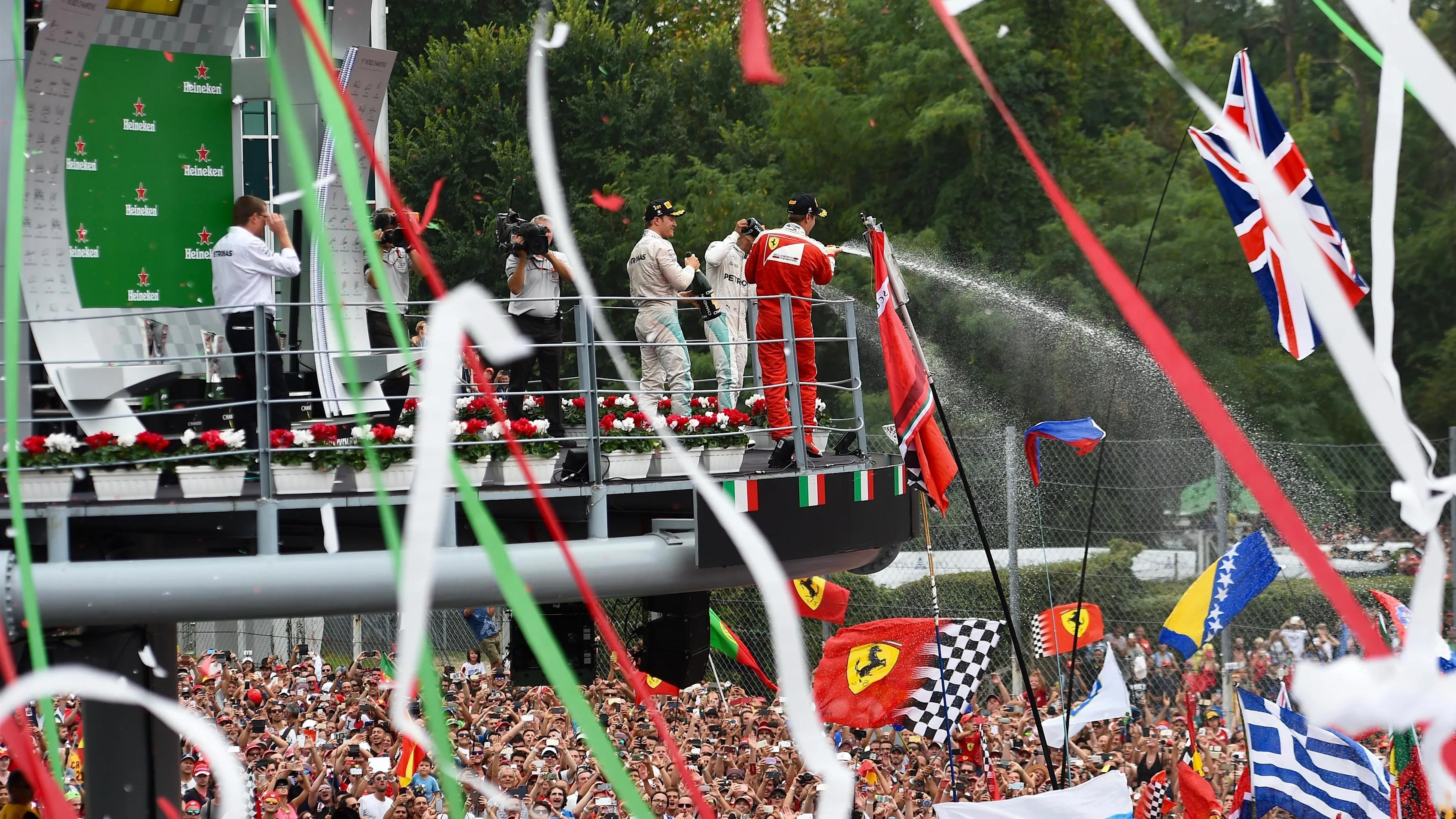 Race winner Nico Rosberg (GER) Mercedes AMG F1 ceebrates with champagne on the podium alongside