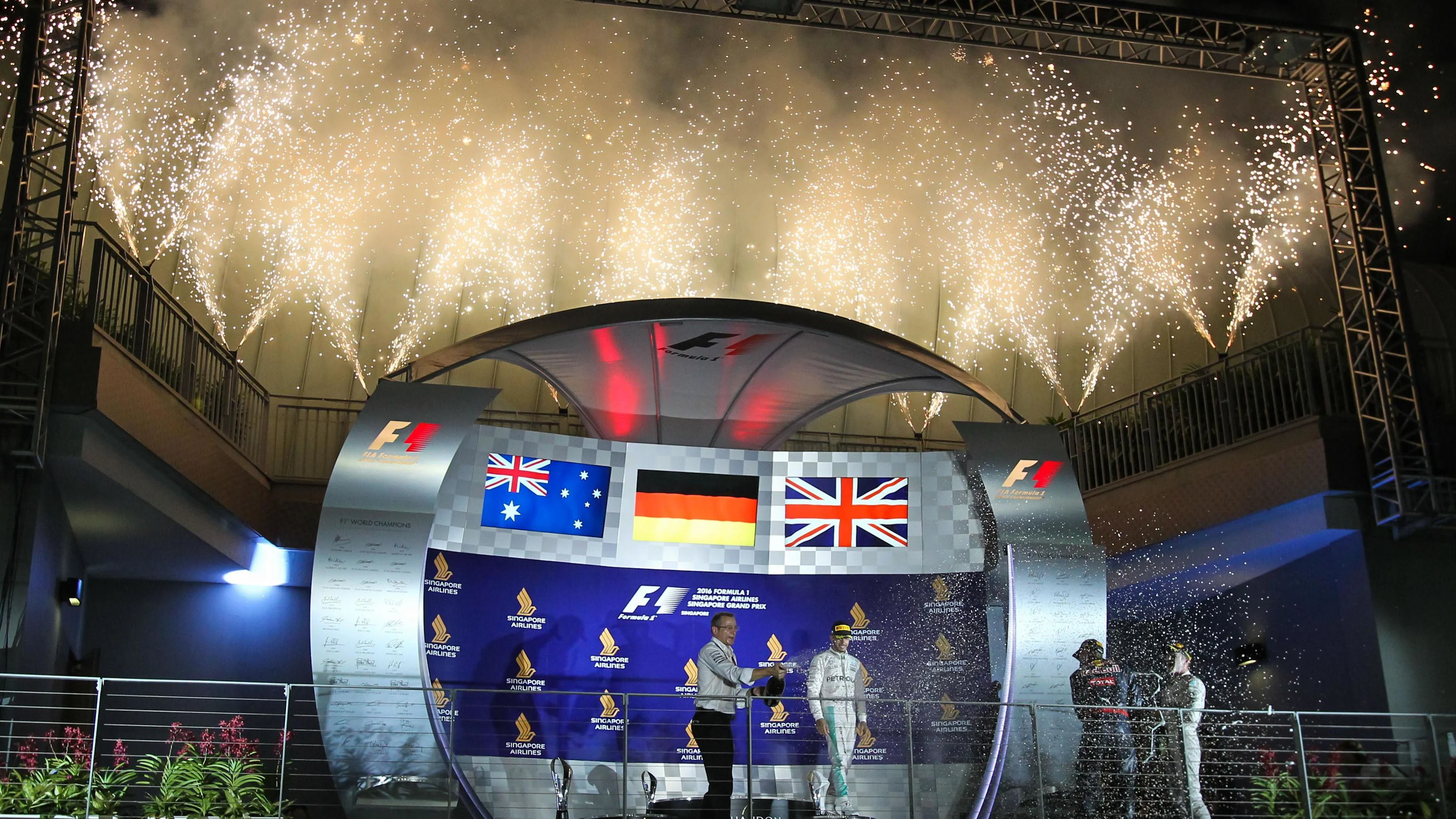 Mark Ellis (GBR) Mercedes AMG F1 Performance Director, Lewis Hamilton (GBR) Mercedes AMG F1, Daniel Ricciardo (AUS) Red Bull Racing and race winner Nico Rosberg (GER) Mercedes AMG F1 celebrate on the podium with the champagne at Formula One World Championship, Rd15, Singapore Grand Prix, Race, Marina Bay Street Circuit, Singapore, Sunday 18 September 2016. © Sutton Images