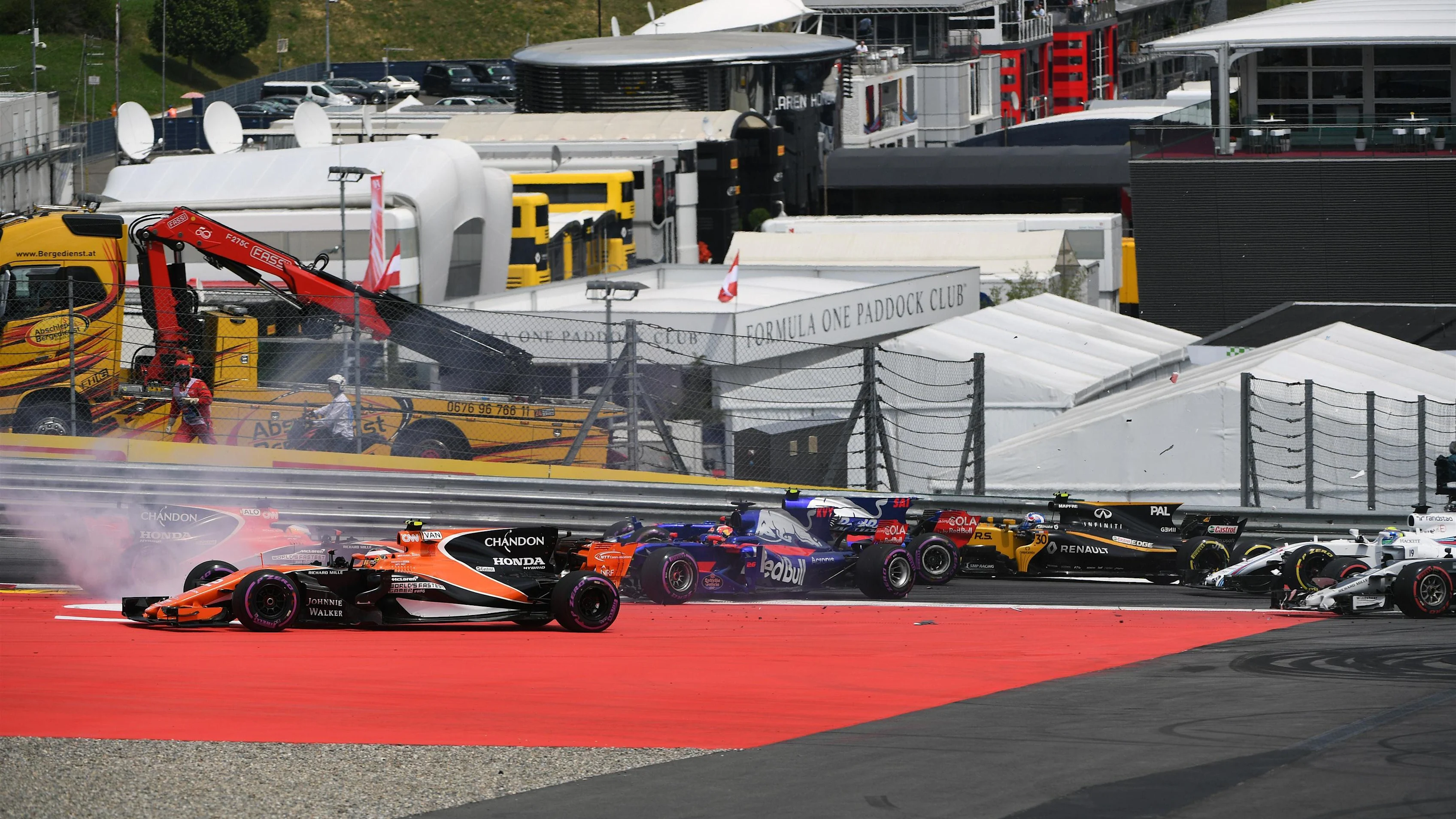 Max Verstappen (NED) Red Bull Racing RB13, Fernando Alonso (ESP) McLaren MCL32 and Daniil Kvyat (RUS) Scuderia Toro Rosso STR12 collide at the start of the race at Formula One World Championship, Rd9, Austrian Grand Prix, Race, Spielberg, Austria, Sunday