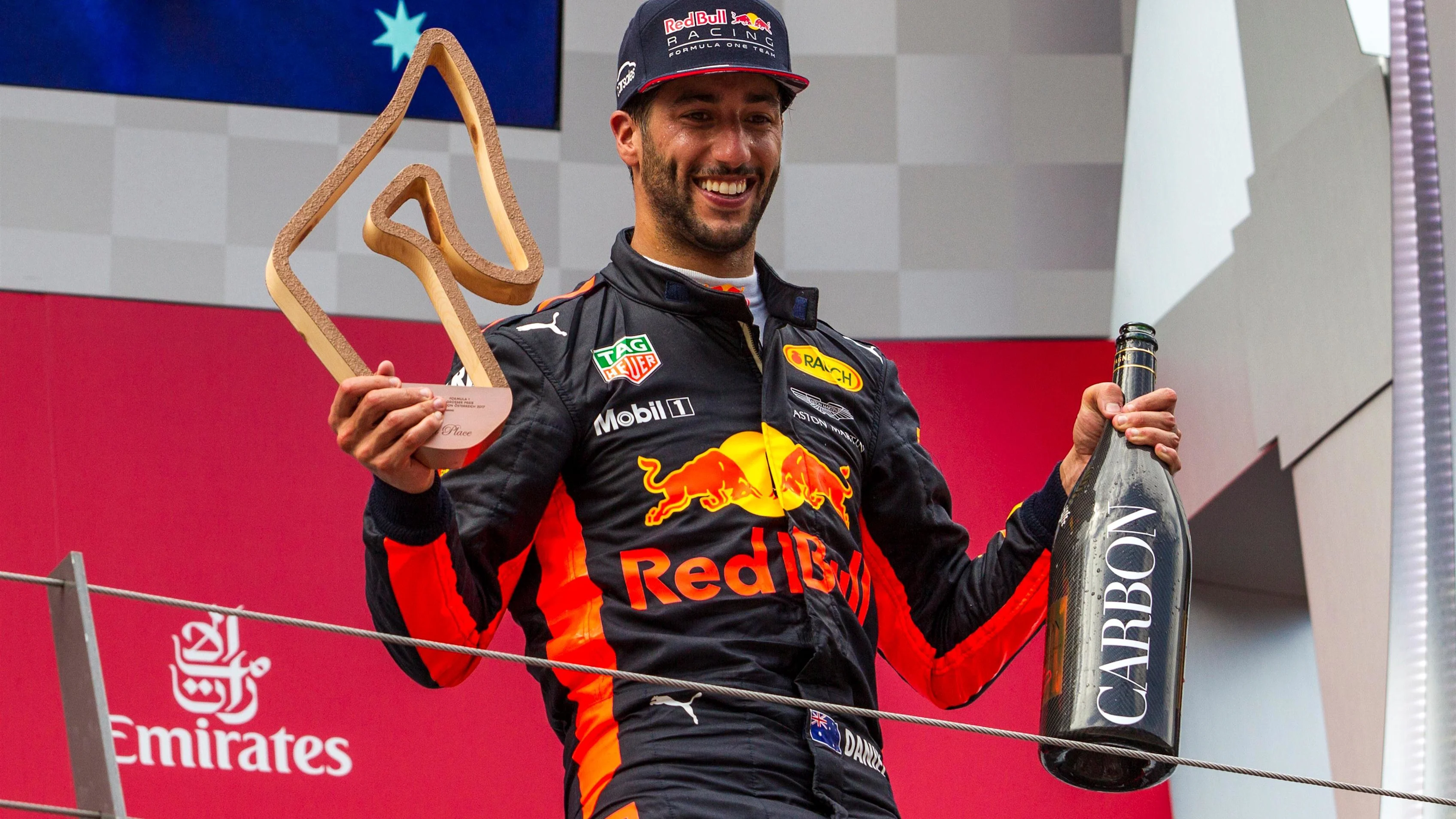 Daniel Ricciardo (AUS) Red Bull Racing celebrates on the podium with the champagne and the trophy