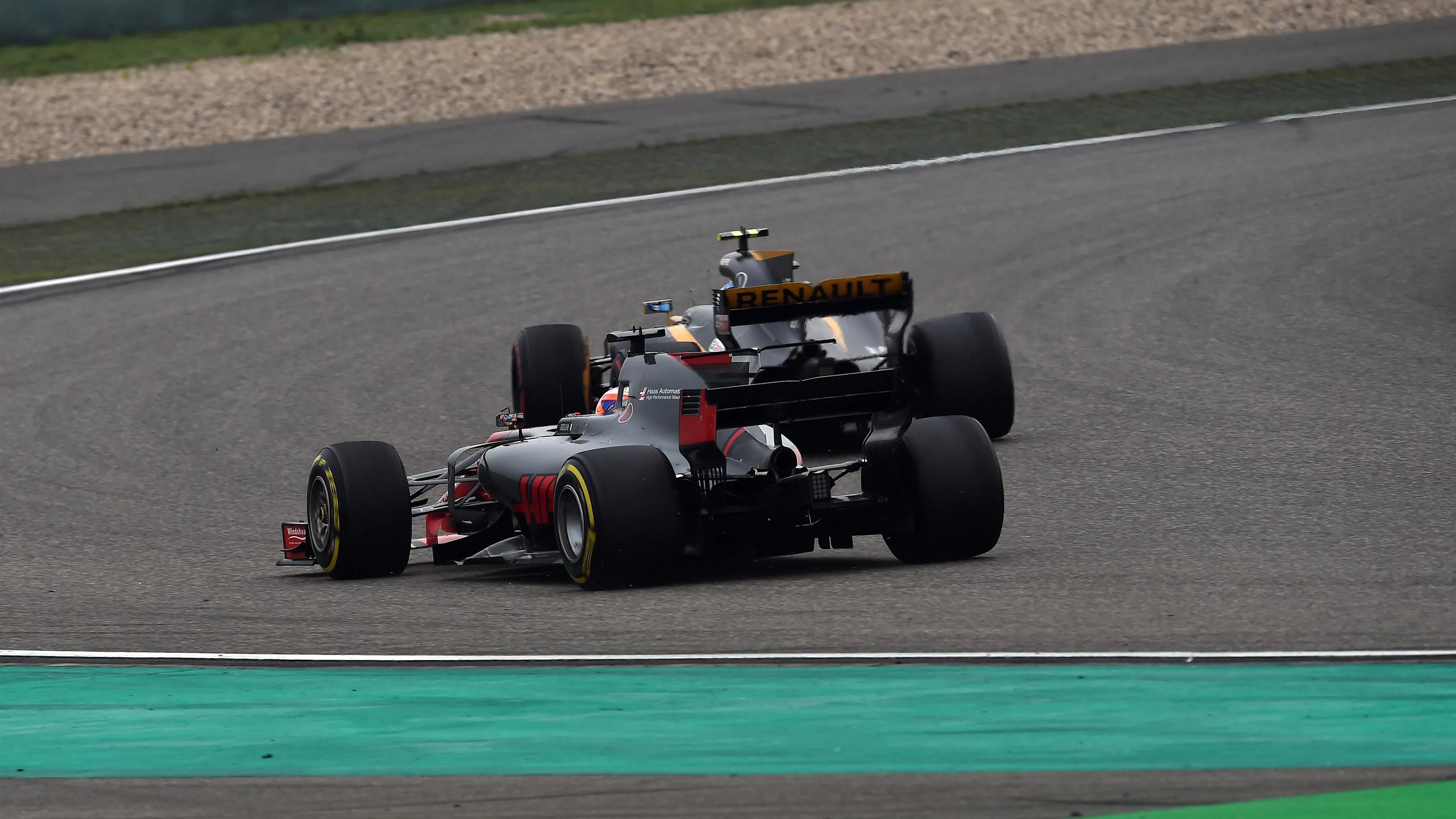Jolyon Palmer (GBR) Renault Sport F1 Team RS17 and Romain Grosjean (FRA) Haas VF-17 battle for position at Formula One World Championship, Rd2, Chinese Grand Prix, Race, Shanghai, China, Sunday 9 April 2017. © Sutton Motorsport Images