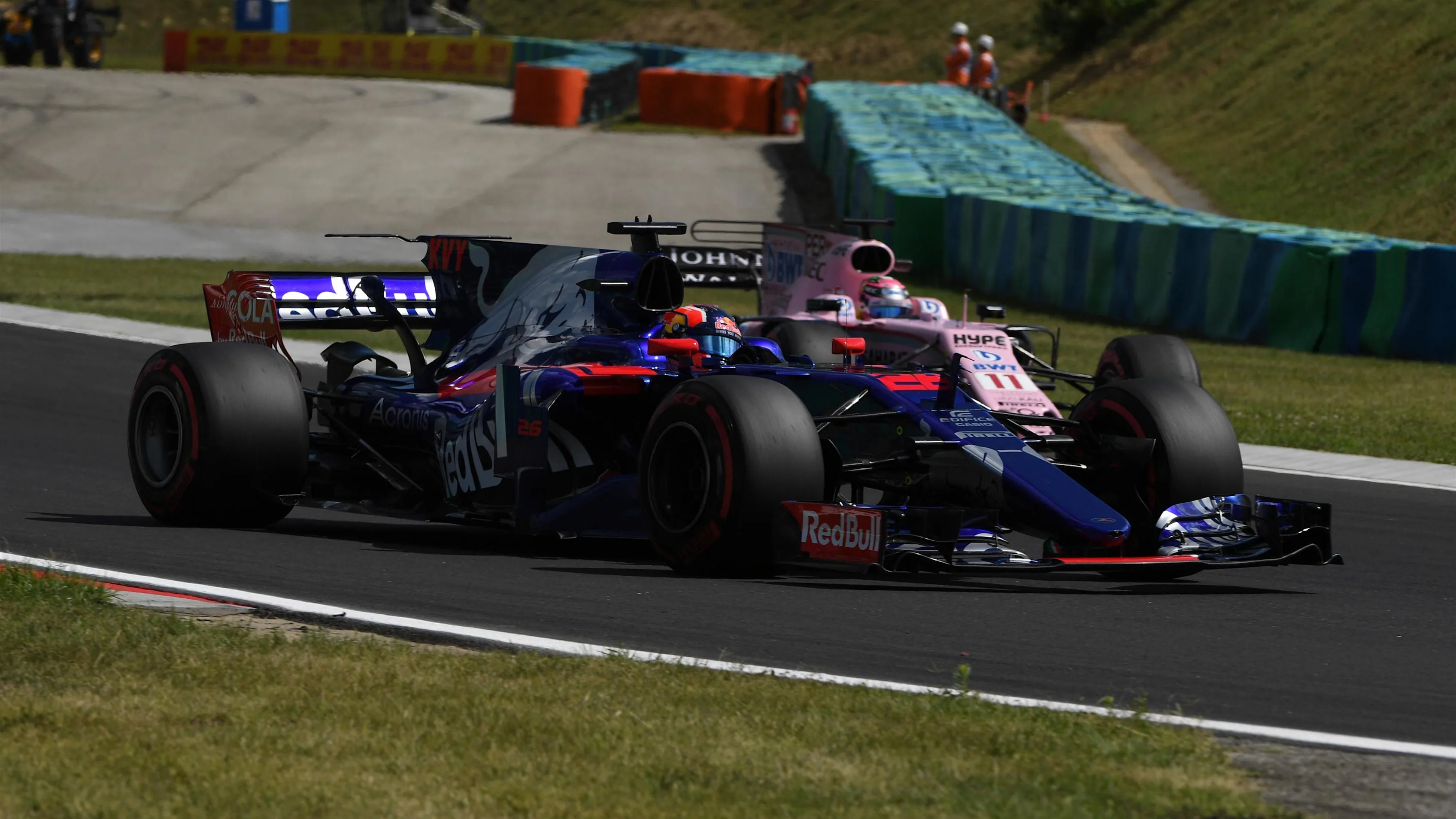 Daniil Kvyat (RUS) Scuderia Toro Rosso STR12 and Esteban Ocon (FRA) Force India VJM10 at Formula