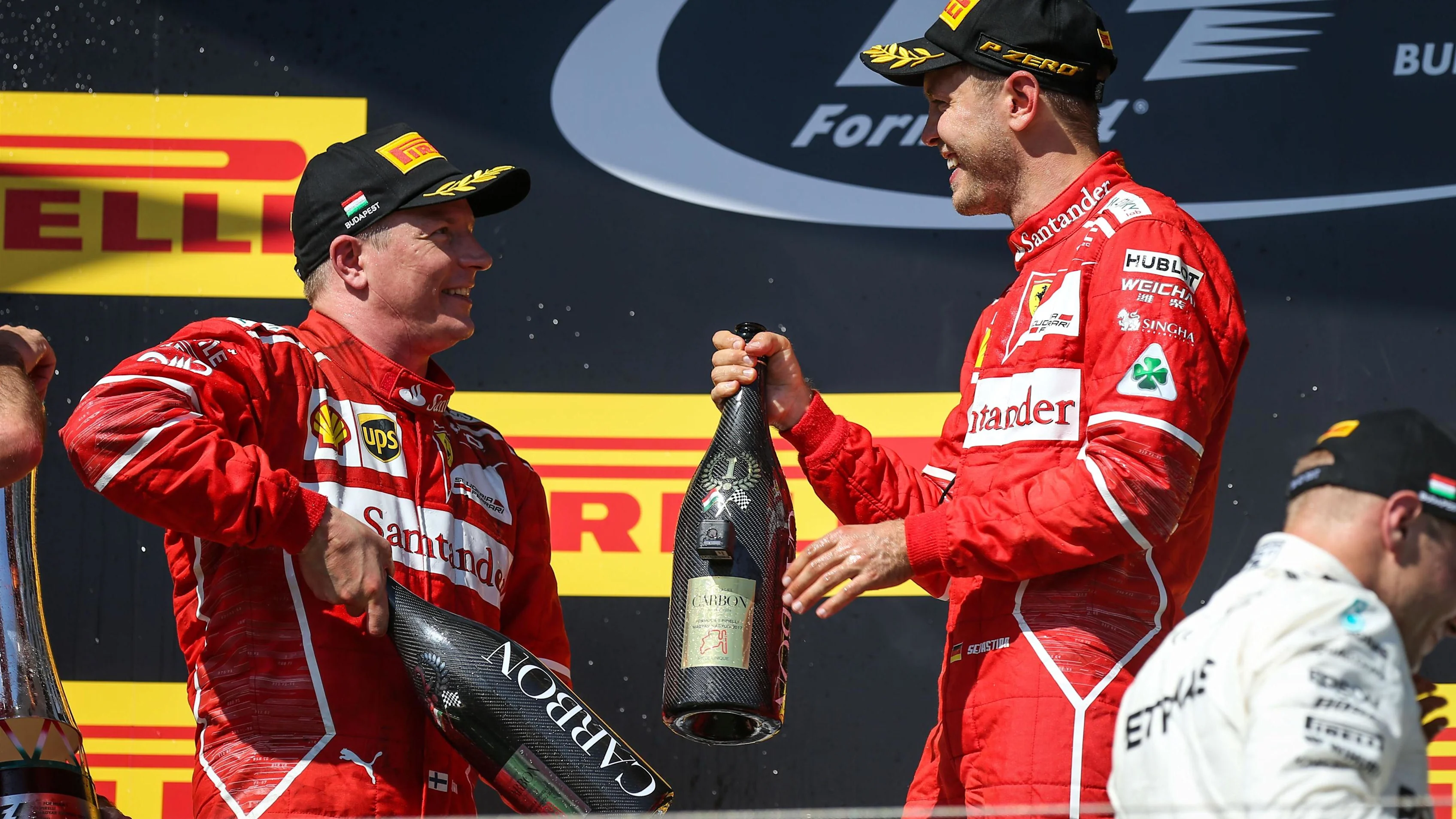 Race winner Sebastian Vettel (GER) Ferrari and Kimi Raikkonen (FIN) Ferrari celebrate on the podium