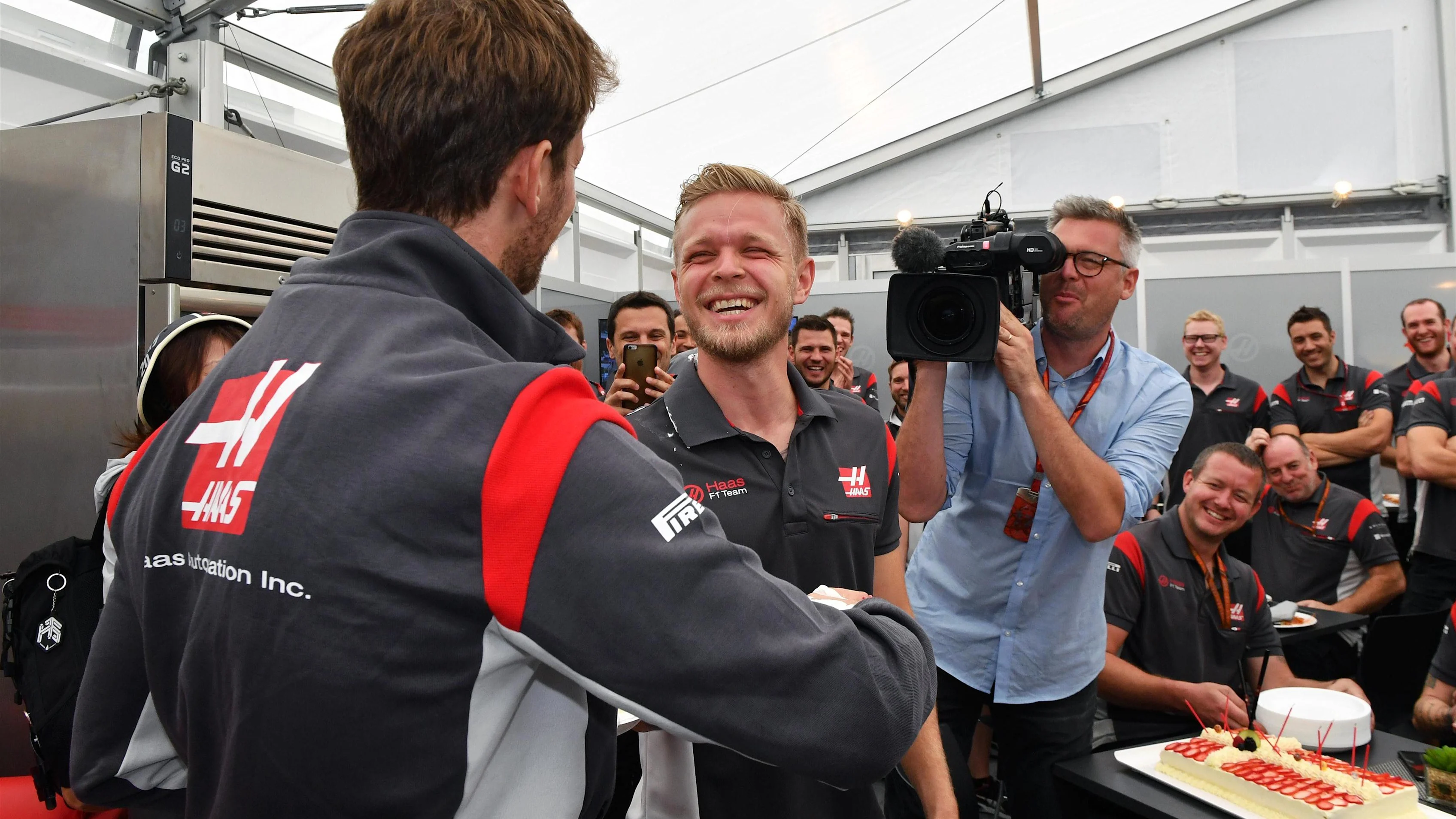 Romain Grosjean (FRA) Haas F1 puts Birthday cake in Kevin Magnussen (DEN) Haas F1 hair at Formula