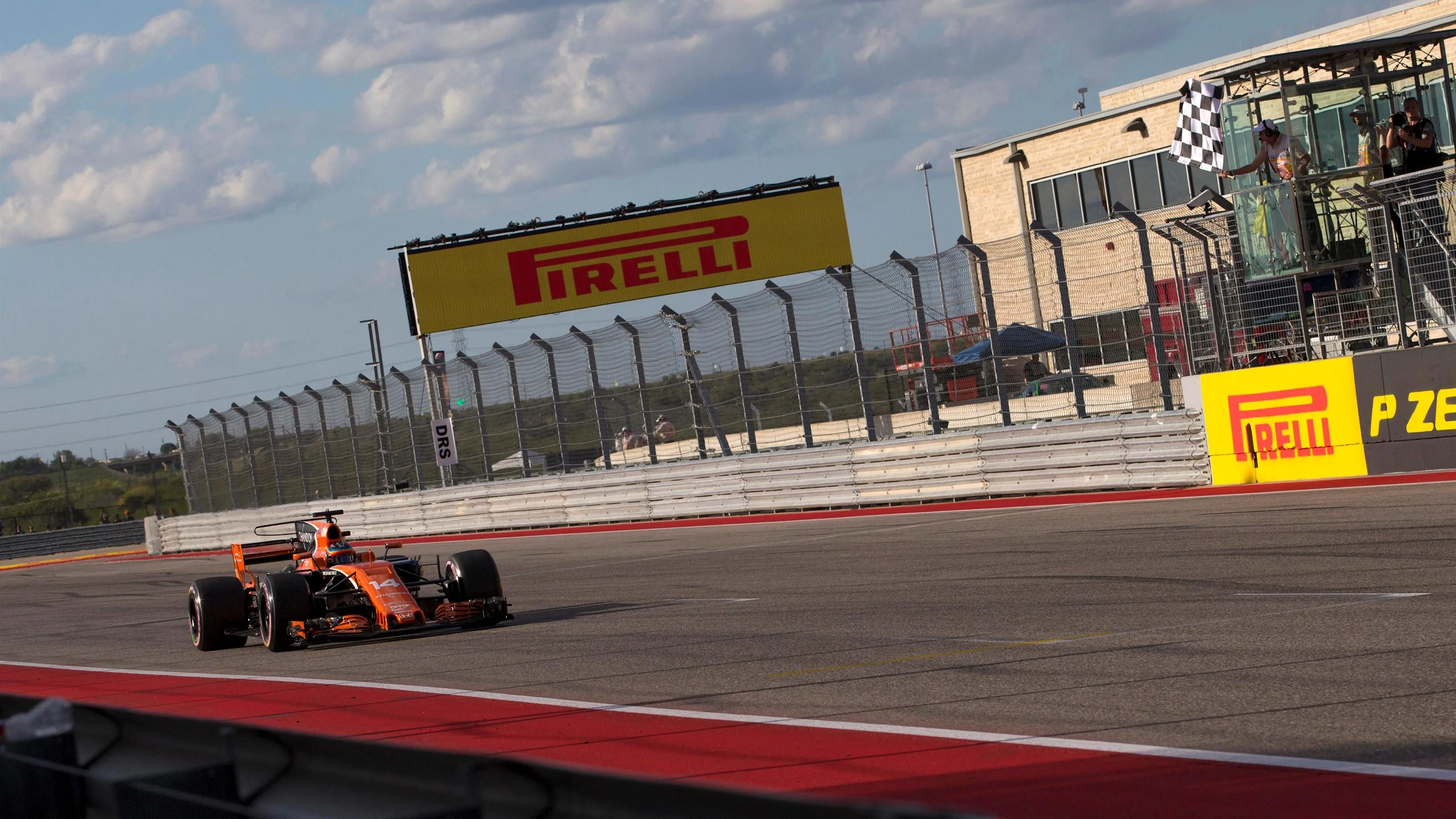 Fernando Alonso (ESP) McLaren MCL32 takes the chequered flag at the end of Qualifying at Formula