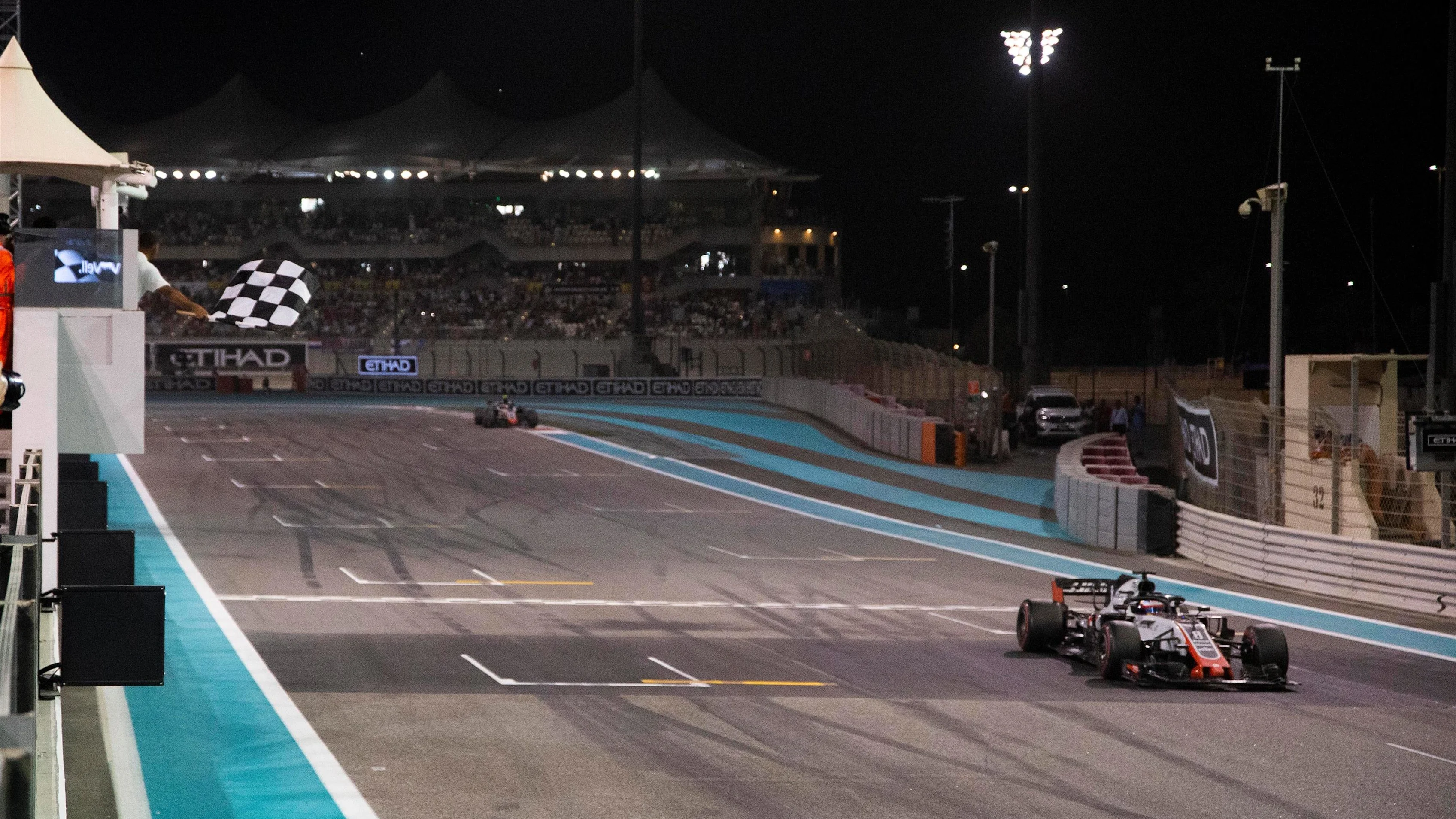 Romain Grosjean, Haas F1 Team VF-18 takes the chequered flag at Formula One World Championship, Rd21, Abu Dhabi Grand Prix, Race, Yas Marina Circuit, Abu Dhabi, UAE, Sunday 25 November 2018.