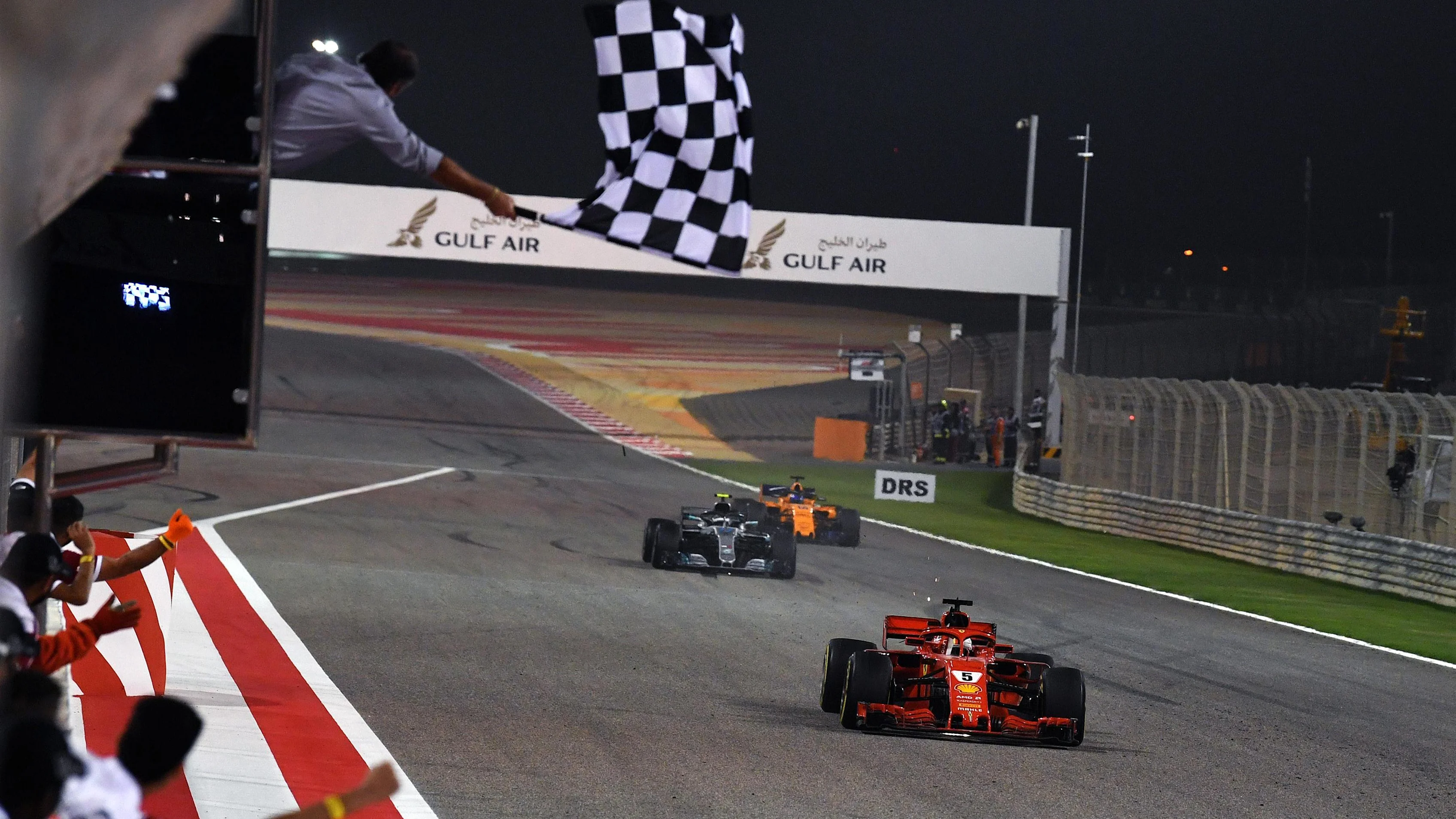 Race winner Sebastian Vettel Ferrari SF-71H crosses the line and takes the chequered flag at Formula One World Championship, Rd2, Bahrain Grand Prix, Race, Bahrain International Circuit, Sakhir, Bahrain, Sunday 8 April 2018. © Mark Sutton/Sutton Images