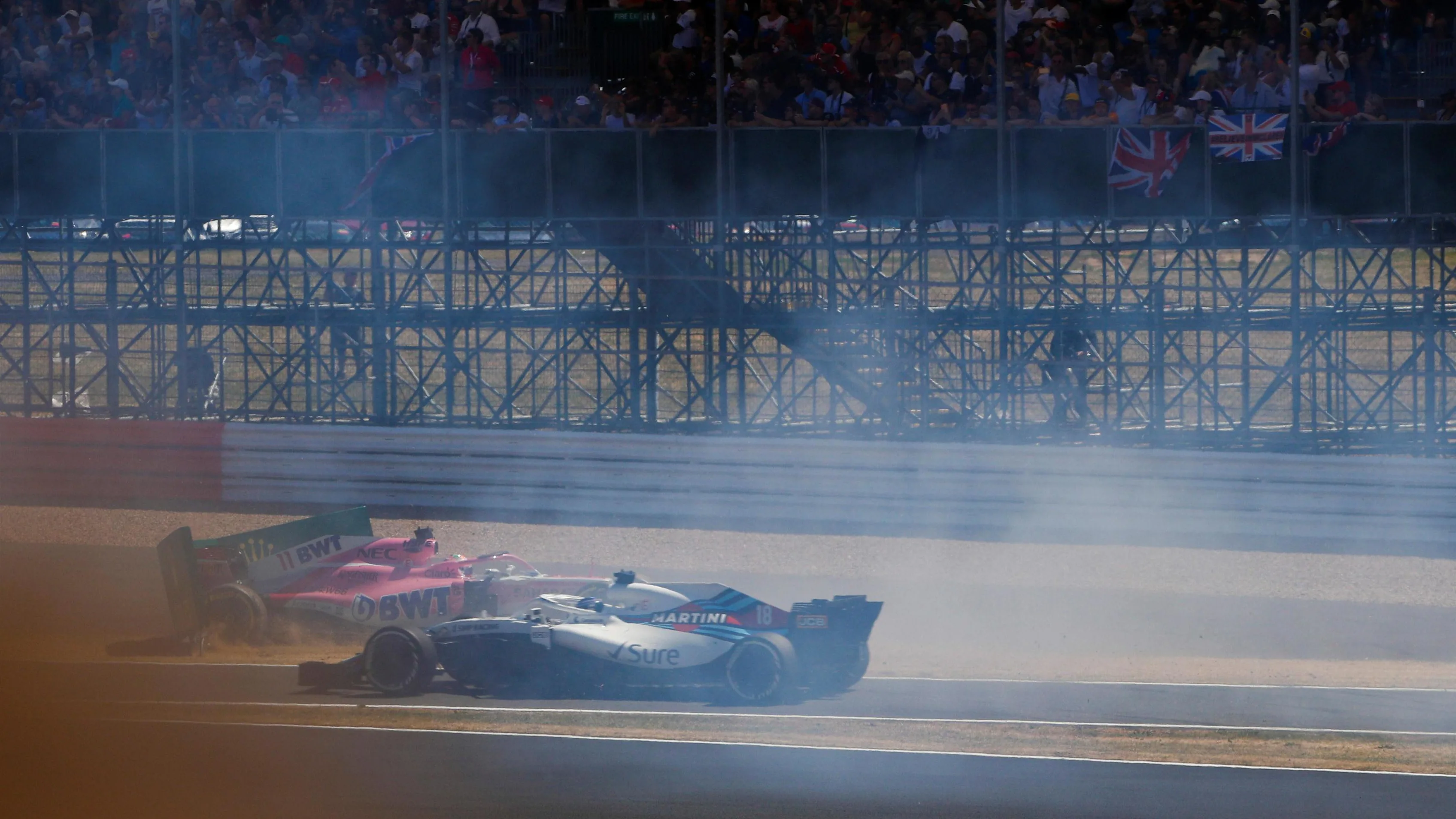 Sergio Perez (MEX) Force India VJM11 spins in front of Sergey Sirotkin (RUS) Williams FW41 at the start of the race at Formula One World Championship, Rd10, British Grand Prix, Race, Silverstone, England, Sunday 8 July 2018. © Glenn Dunbar/LAT/Sutton Images