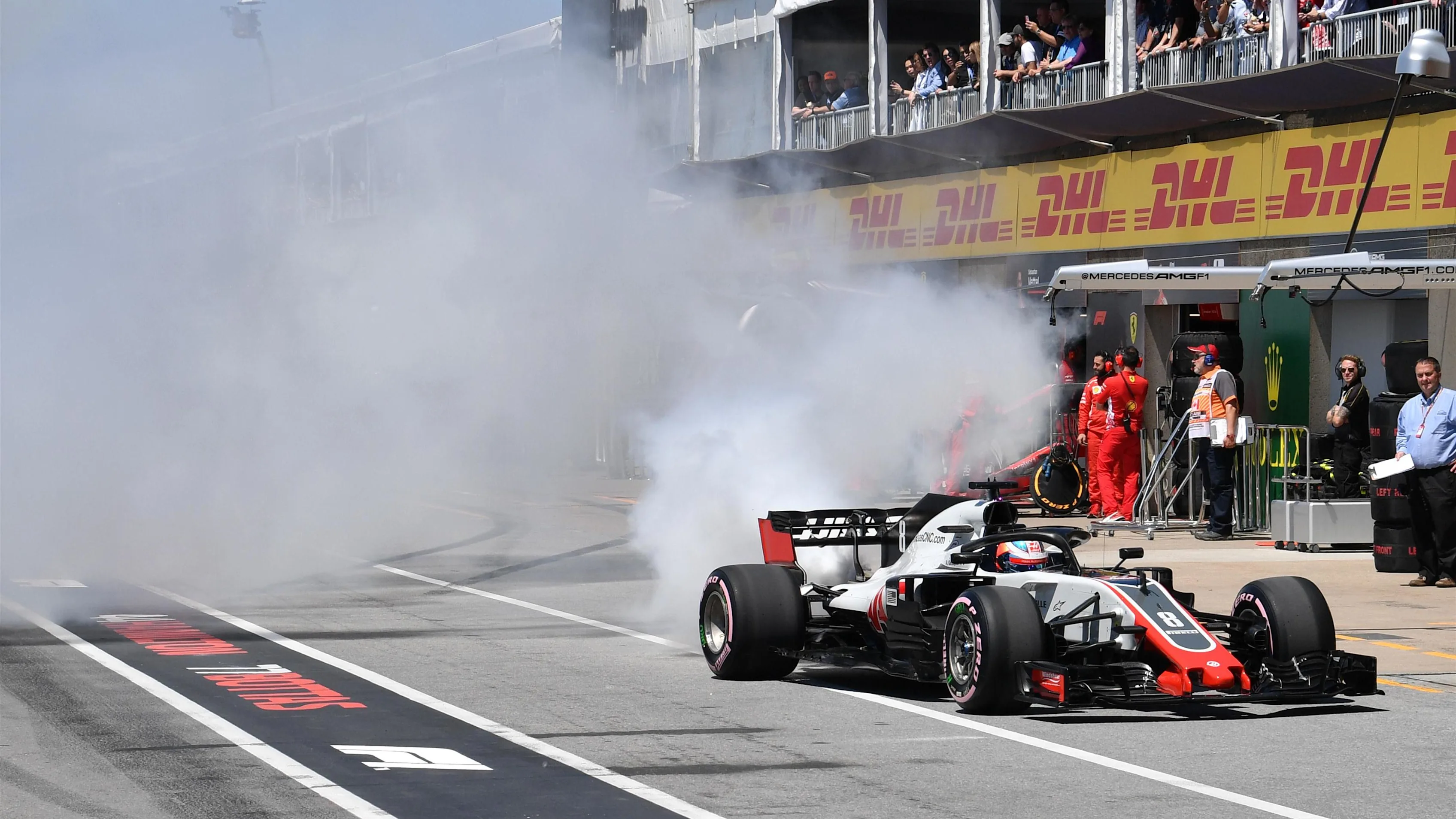 Romain Grosjean (FRA) Haas VF-18 smokes in pit lane in Q1 at Formula One World Championship, Rd7,