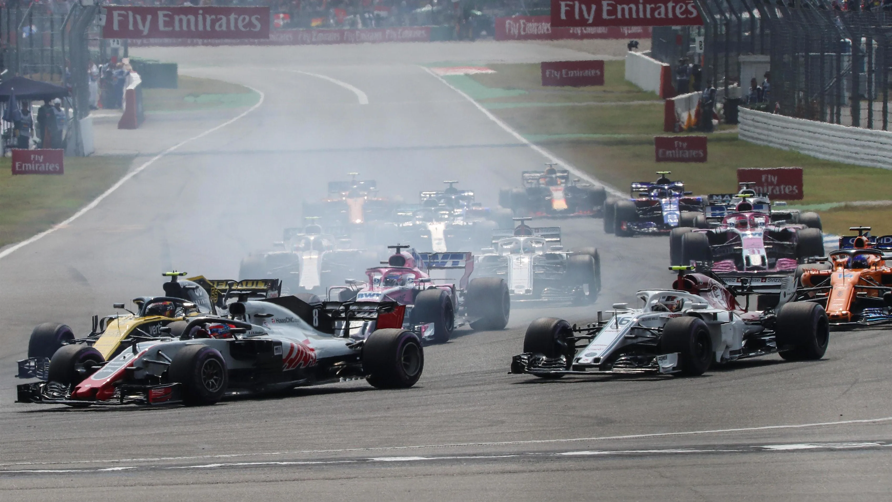 Romain Grosjean (FRA) Haas VF-18 and Carlos Sainz (ESP) Renault Sport F1 Team RS18 battle on lap one at Formula One World Championship, Rd11, German Grand Prix, Race, Hockenheim, Germany, Sunday 22 July 2018. © Manuel Goria/Sutton Images