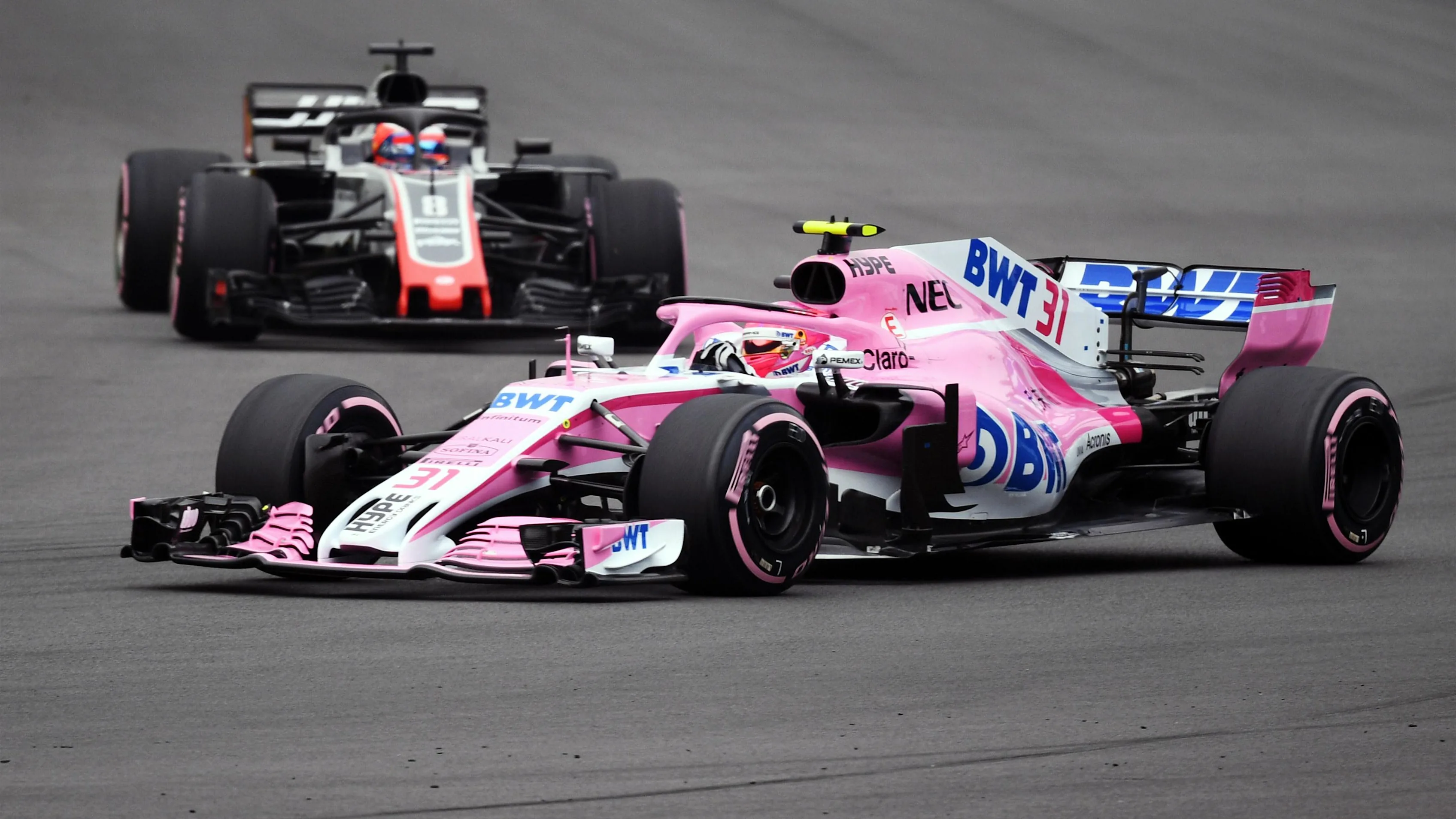 Esteban Ocon, Racing Point Force India VJM11 and Romain Grosjean, Haas F1 Team VF-18 at Formula One