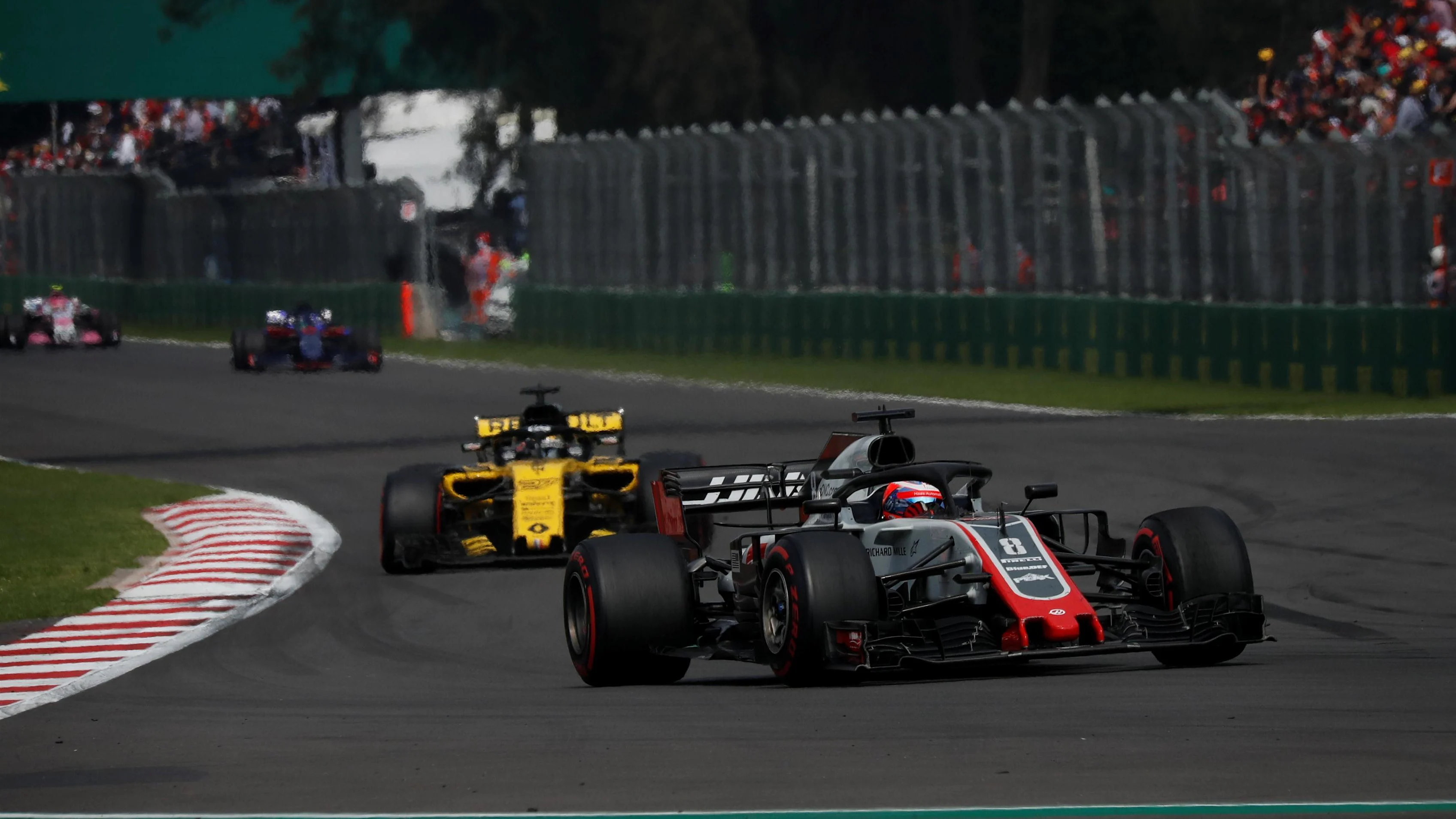 Romain Grosjean, Haas F1 Team VF-18 and Nico Hulkenberg, Renault Sport F1 Team R.S. 18 at Formula