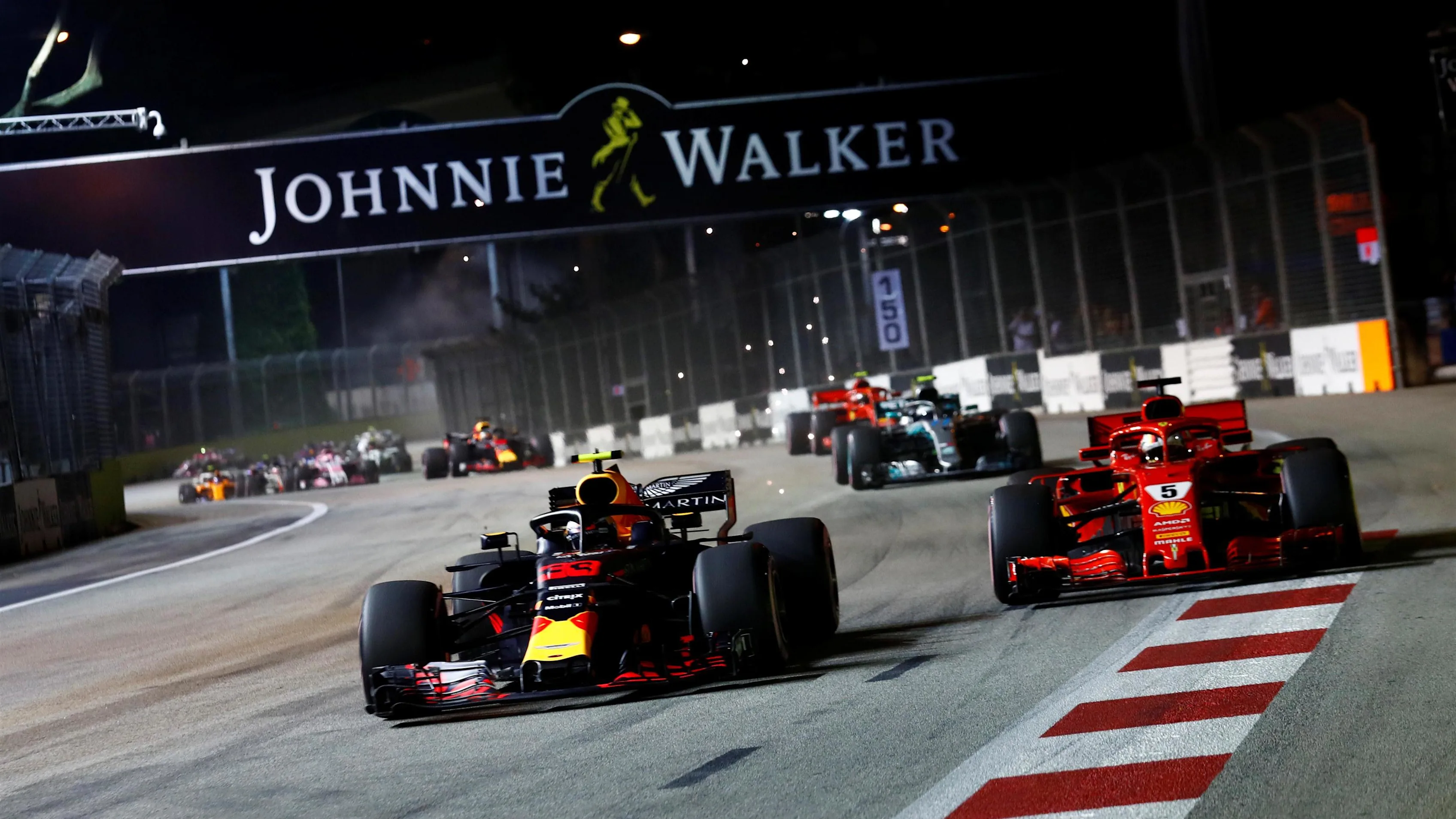 Max Verstappen, Red Bull Racing RB14 and Sebastian Vettel, Ferrari SF71H battle on lap one at Formula One World Championship, Rd15, Singapore Grand Prix, Race, Marina Bay Circuit, Singapore, Sunday 16 September 2018.