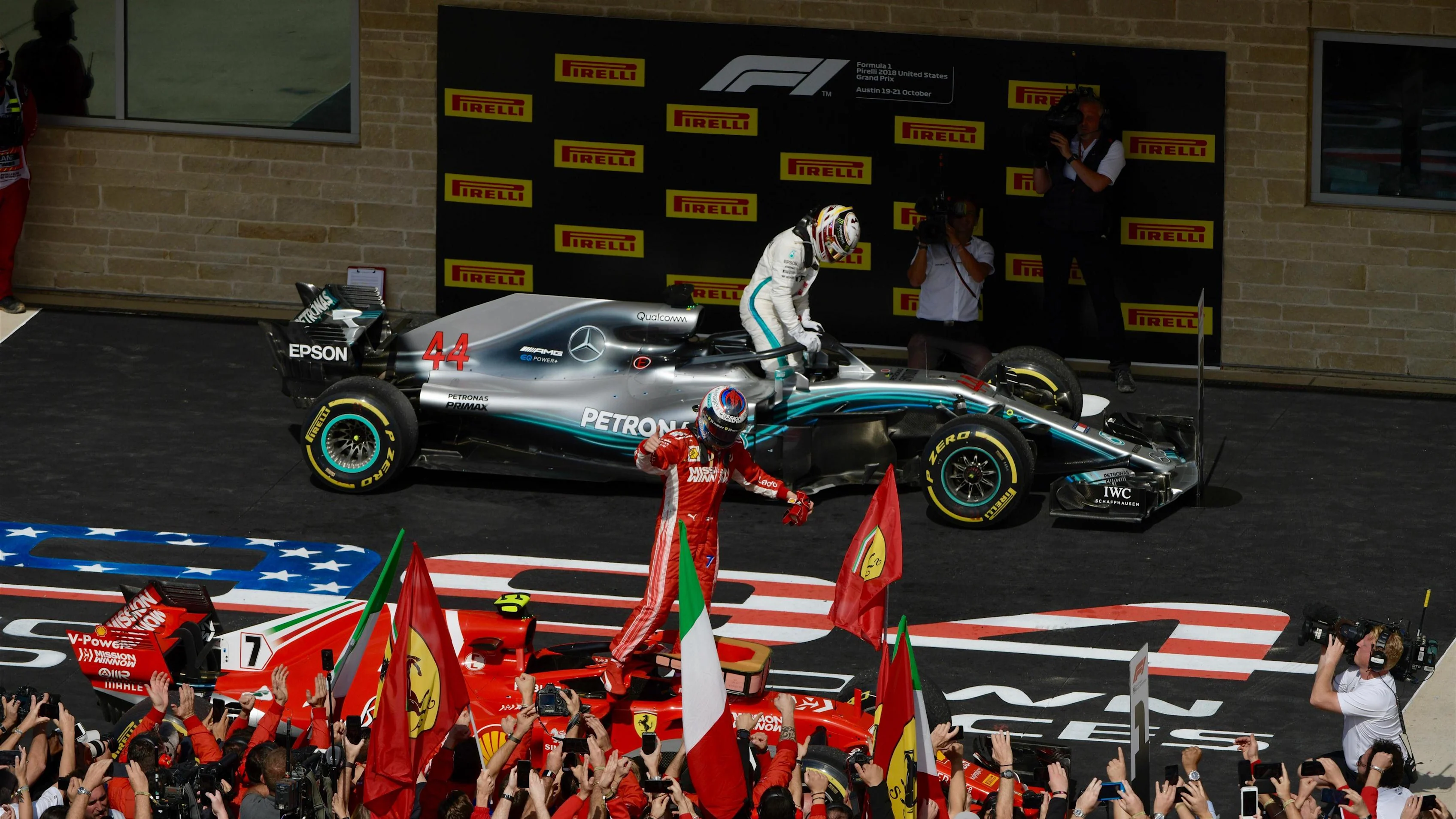 Race winner Kimi Raikkonen, Ferrari SF71H celebrates in Parc Ferme with Lewis Hamilton,