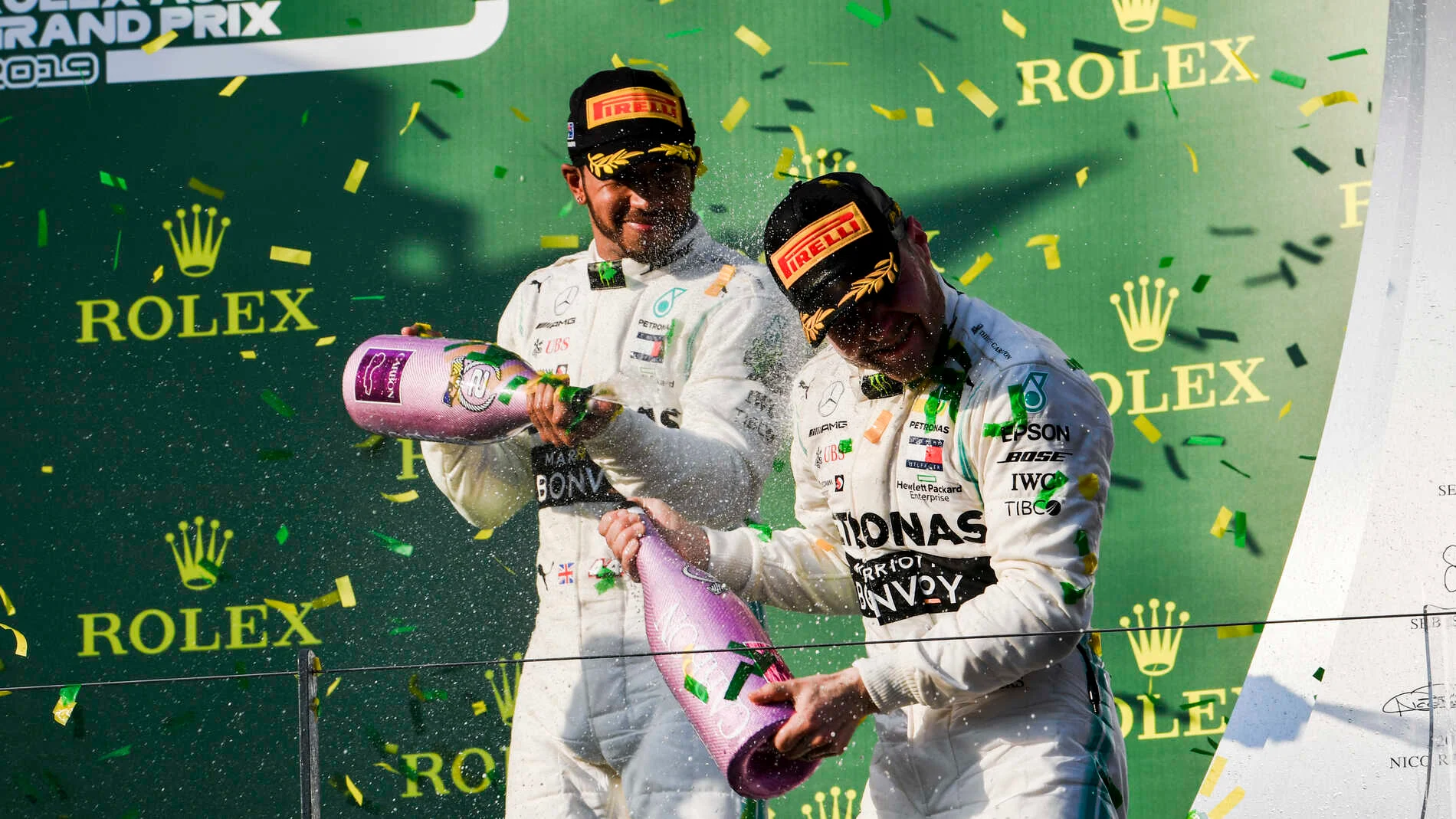 MELBOURNE GRAND PRIX CIRCUIT, AUSTRALIA - MARCH 17: Lewis Hamilton, Mercedes AMG F1, 2nd position, sprays Valtteri Bottas, Mercedes AMG F1, 1st position, with Champagne on the podium during the Australian GP at Melbourne Grand Prix Circuit on March 17, 2019 in Melbourne Grand Prix Circuit, Australia. (Photo by Mark Sutton / Sutton Images)