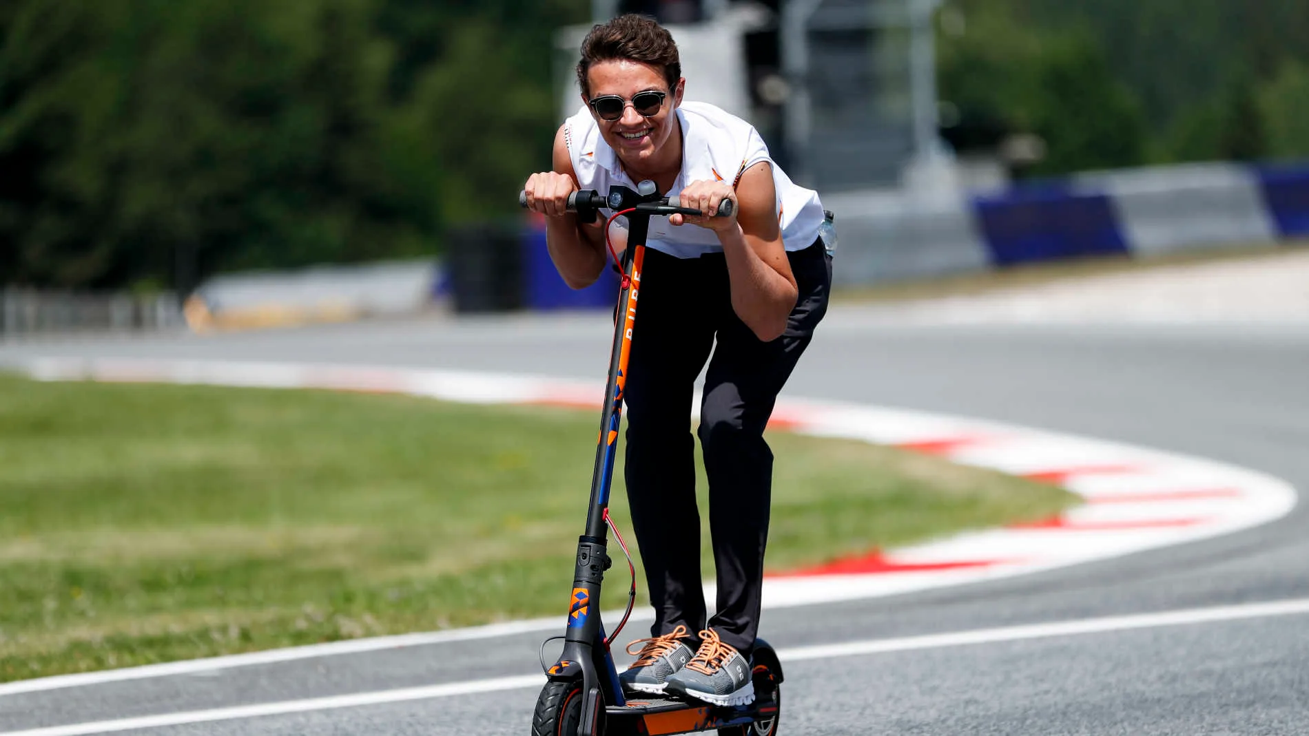 RED BULL RING, AUSTRIA - JUNE 27: Lando Norris, McLaren walks the track on scooters during the