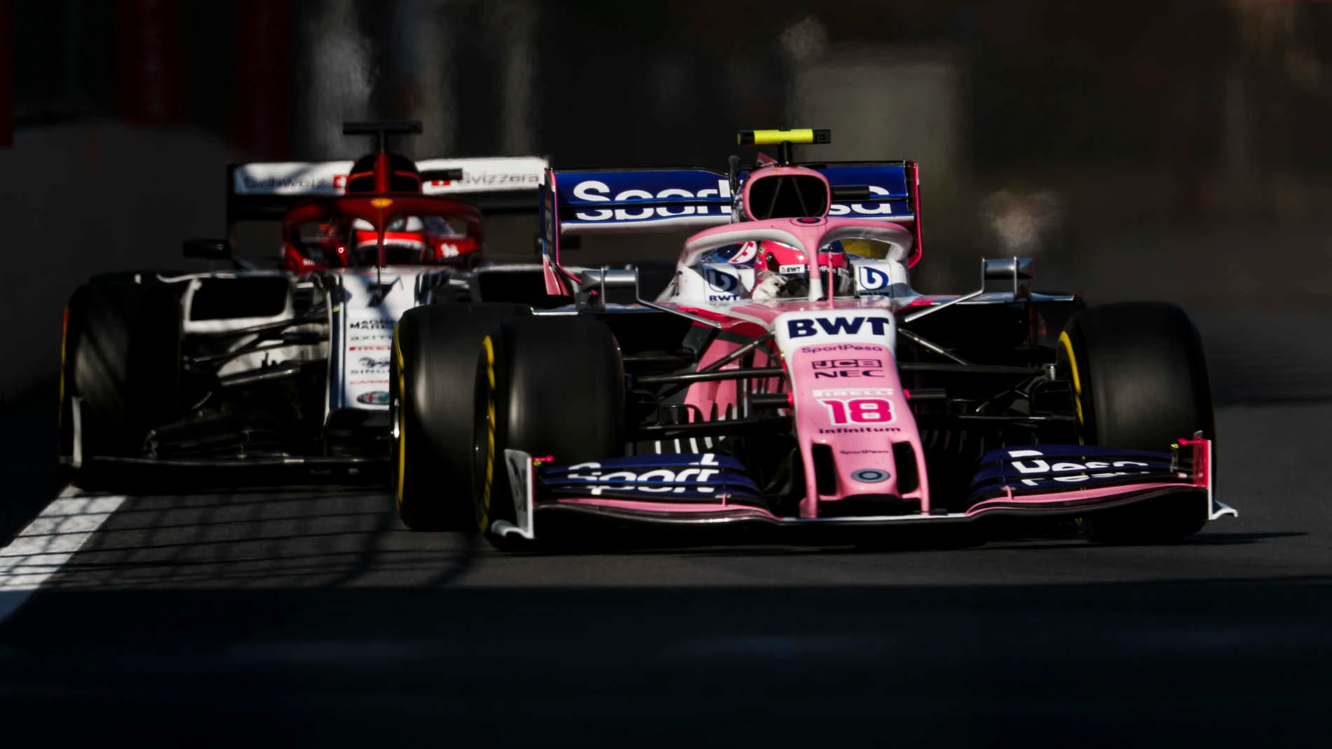 BAKU CITY CIRCUIT, AZERBAIJAN - APRIL 28: Lance Stroll, Racing Point RP19, leads Kimi Raikkonen, Alfa Romeo Racing C38 during the Azerbaijan GP at Baku City Circuit on April 28, 2019 in Baku City Circuit, Azerbaijan. (Photo by Zak Mauger / LAT Images)