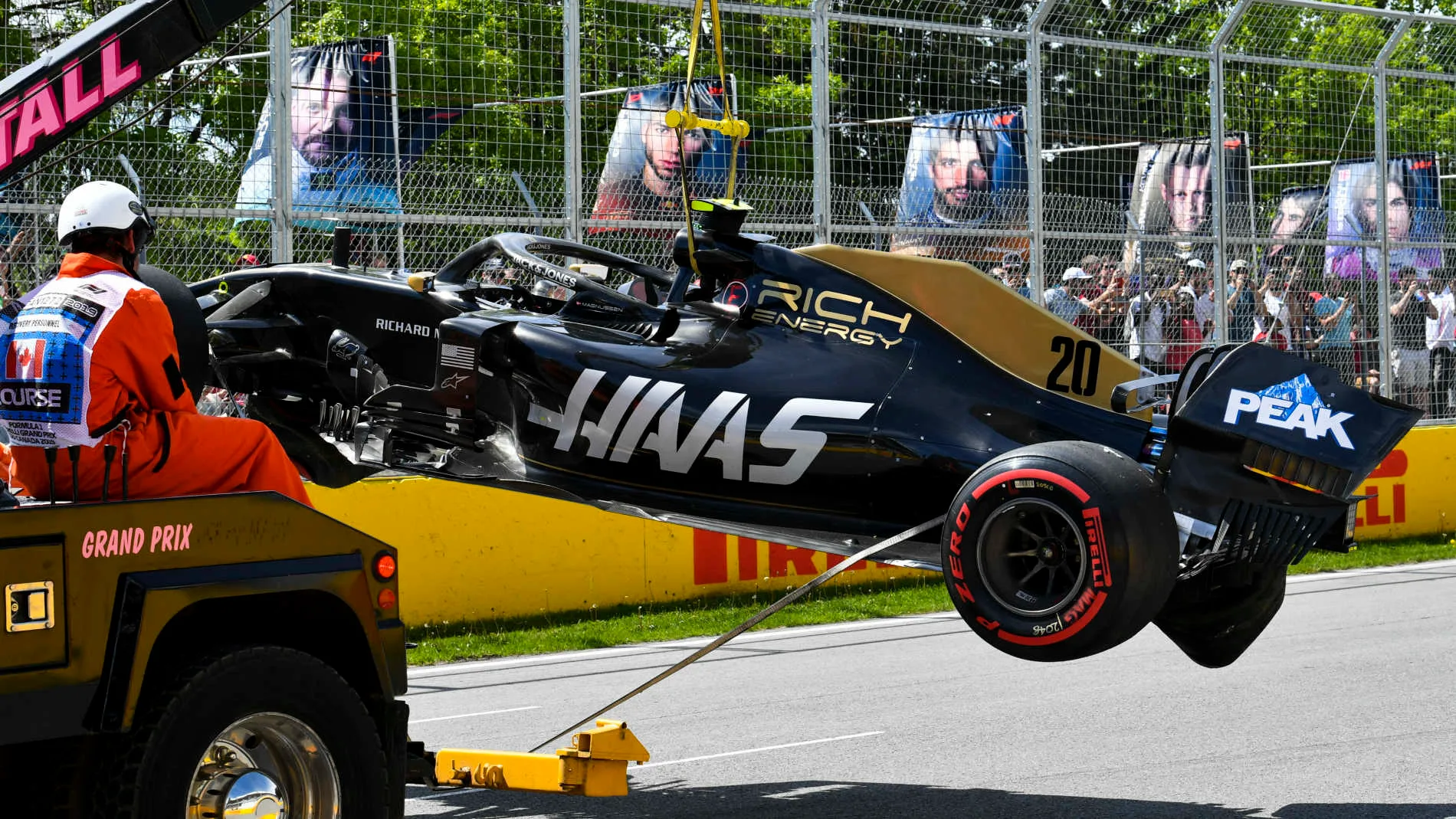 CIRCUIT GILLES-VILLENEUVE, CANADA - JUNE 08: Marshals remove the damaged car of Kevin Magnussen,