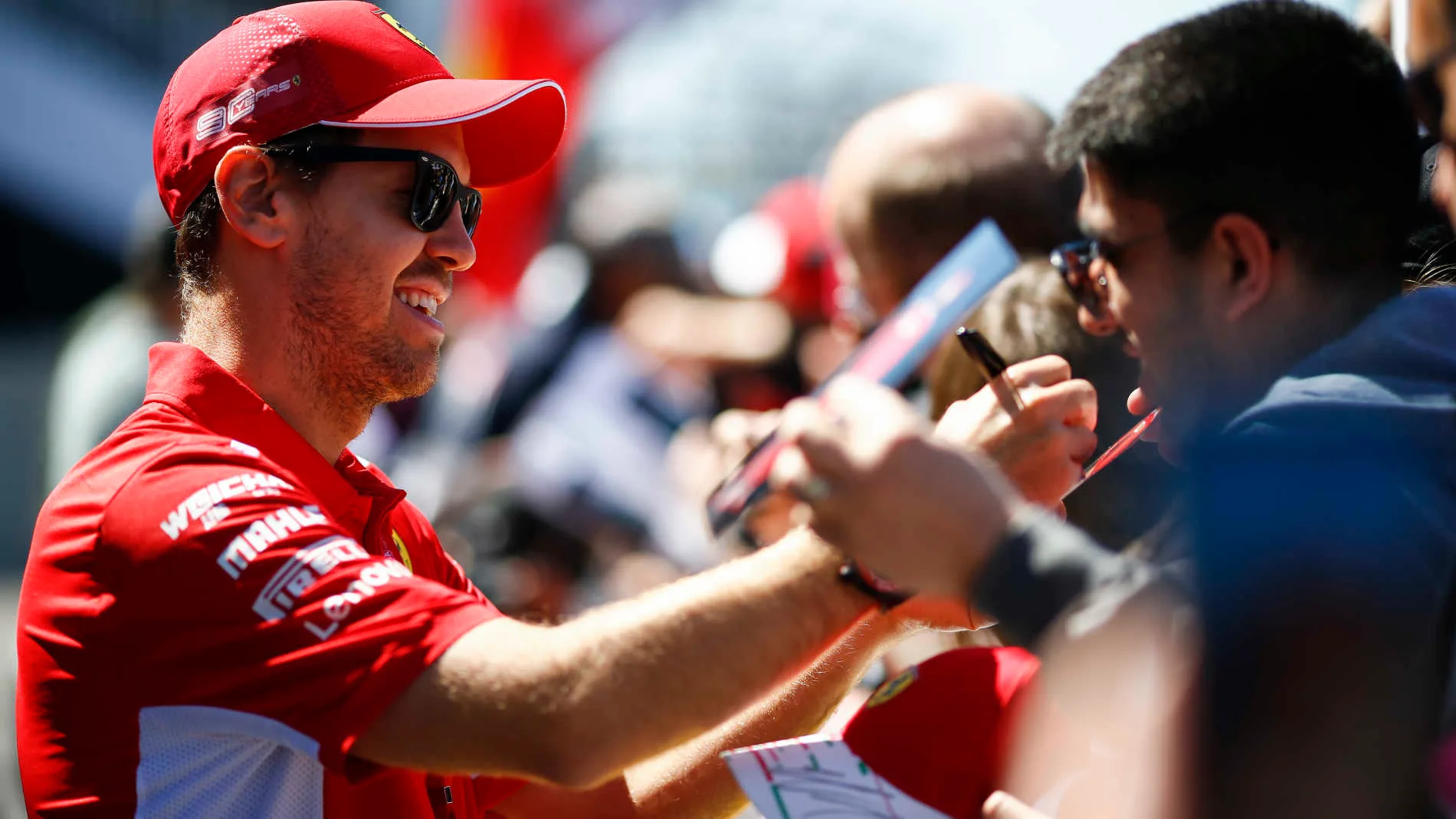 CIRCUIT GILLES-VILLENEUVE, CANADA - JUNE 06: Sebastian Vettel, Ferrari signs a autograph for a fan