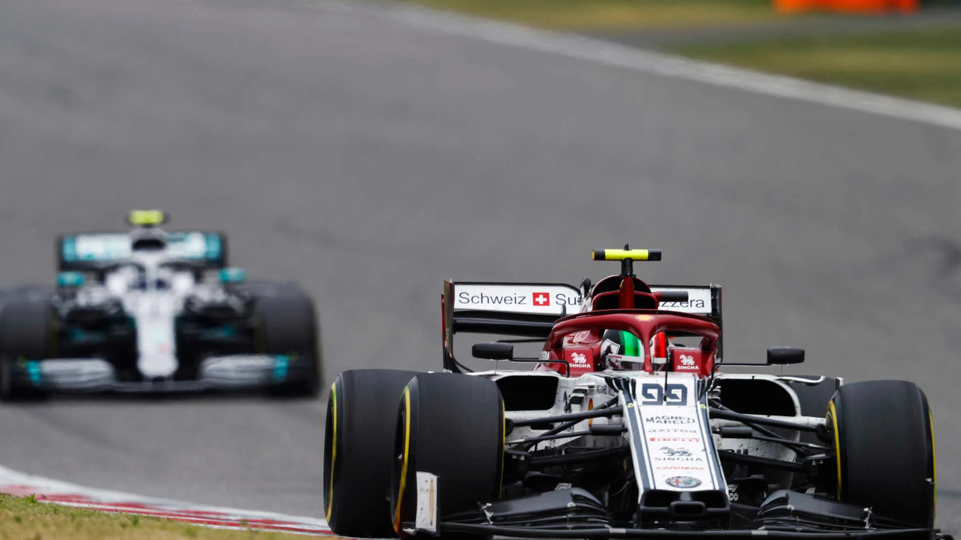 SHANGHAI INTERNATIONAL CIRCUIT, CHINA - APRIL 14: Antonio Giovinazzi, Alfa Romeo Racing C38, leads Valtteri Bottas, Mercedes AMG W10 during the Chinese GP at Shanghai International Circuit on April 14, 2019 in Shanghai International Circuit, China. (Photo by Glenn Dunbar / LAT Images)