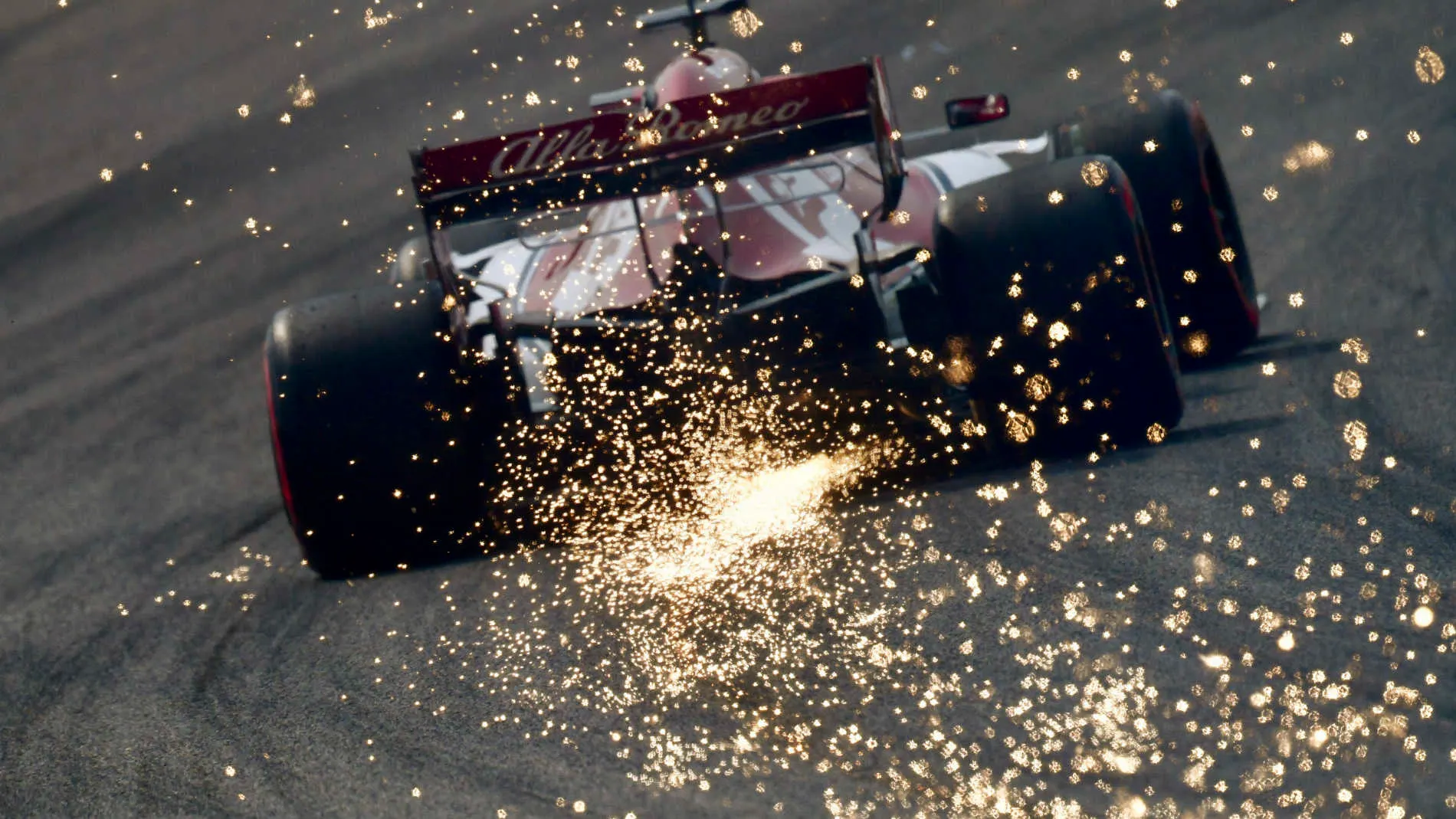 SHANGHAI INTERNATIONAL CIRCUIT, CHINA - APRIL 13: Sparks kick up from the rear of Kimi Raikkonen,