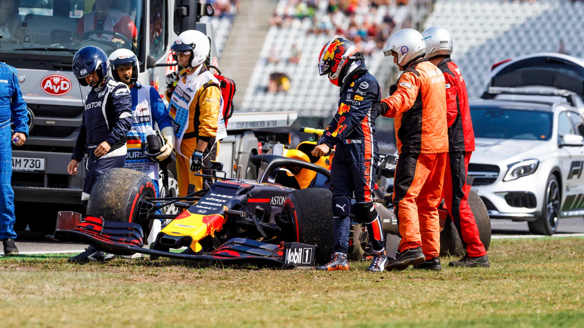 HOCKENHEIMRING, GERMANY - JULY 26: Marshals and doctors assist Pierre Gasly, Red Bull Racing RB15,