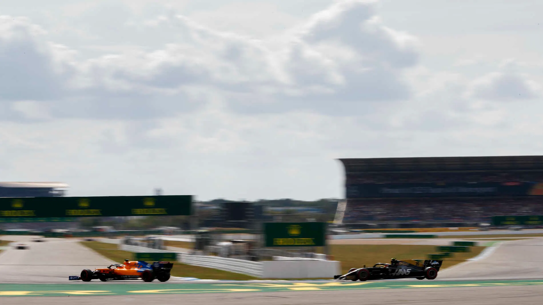 HOCKENHEIMRING, GERMANY - JULY 27: Carlos Sainz Jr., McLaren MCL34, leads Kevin Magnussen, Haas