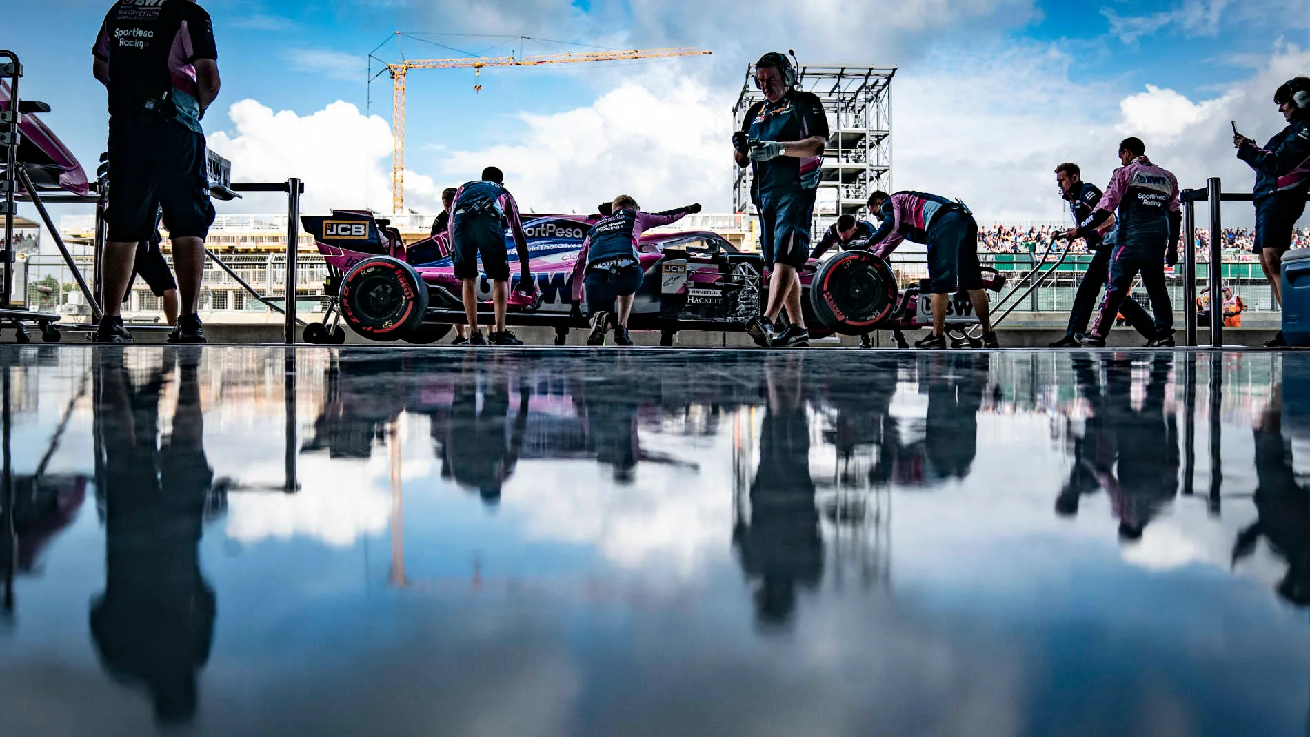 SILVERSTONE, UNITED KINGDOM - JULY 12: Sergio Perez, Racing Point RP19, outside the garage with Racing Point mechanics during the British GP at Silverstone on July 12, 2019 in Silverstone, United Kingdom. (Photo by Glenn Dunbar / LAT Images)