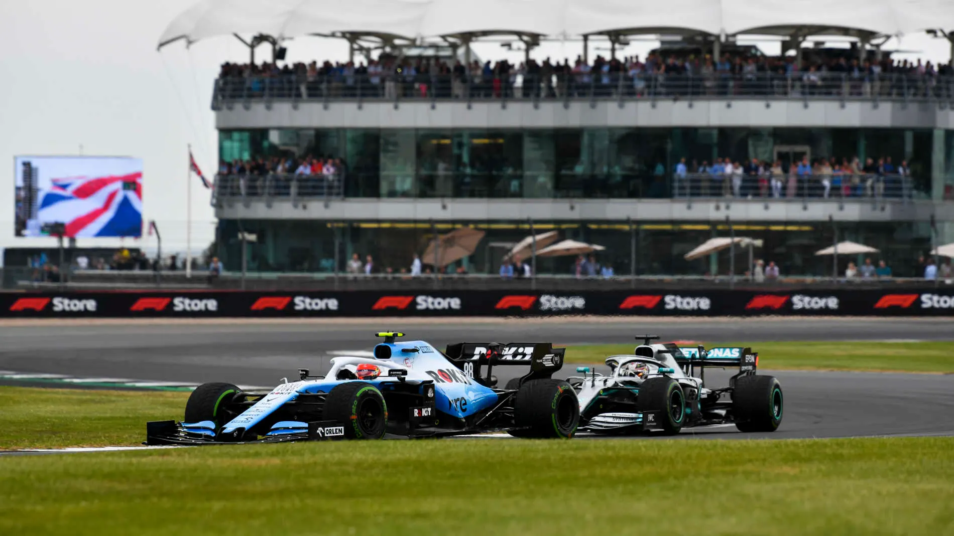 SILVERSTONE, UNITED KINGDOM - JULY 13: Robert Kubica, Williams FW42, leads Lewis Hamilton, Mercedes