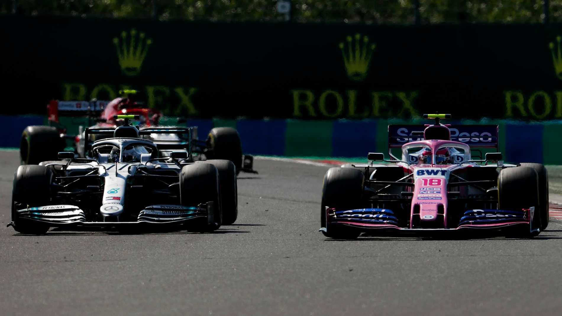 HUNGARORING, HUNGARY - AUGUST 04: Valtteri Bottas, Mercedes AMG W10, battles with Lance Stroll, Racing Point RP19 during the Hungarian GP at Hungaroring on August 04, 2019 in Hungaroring, Hungary. (Photo by Zak Mauger / LAT Images)