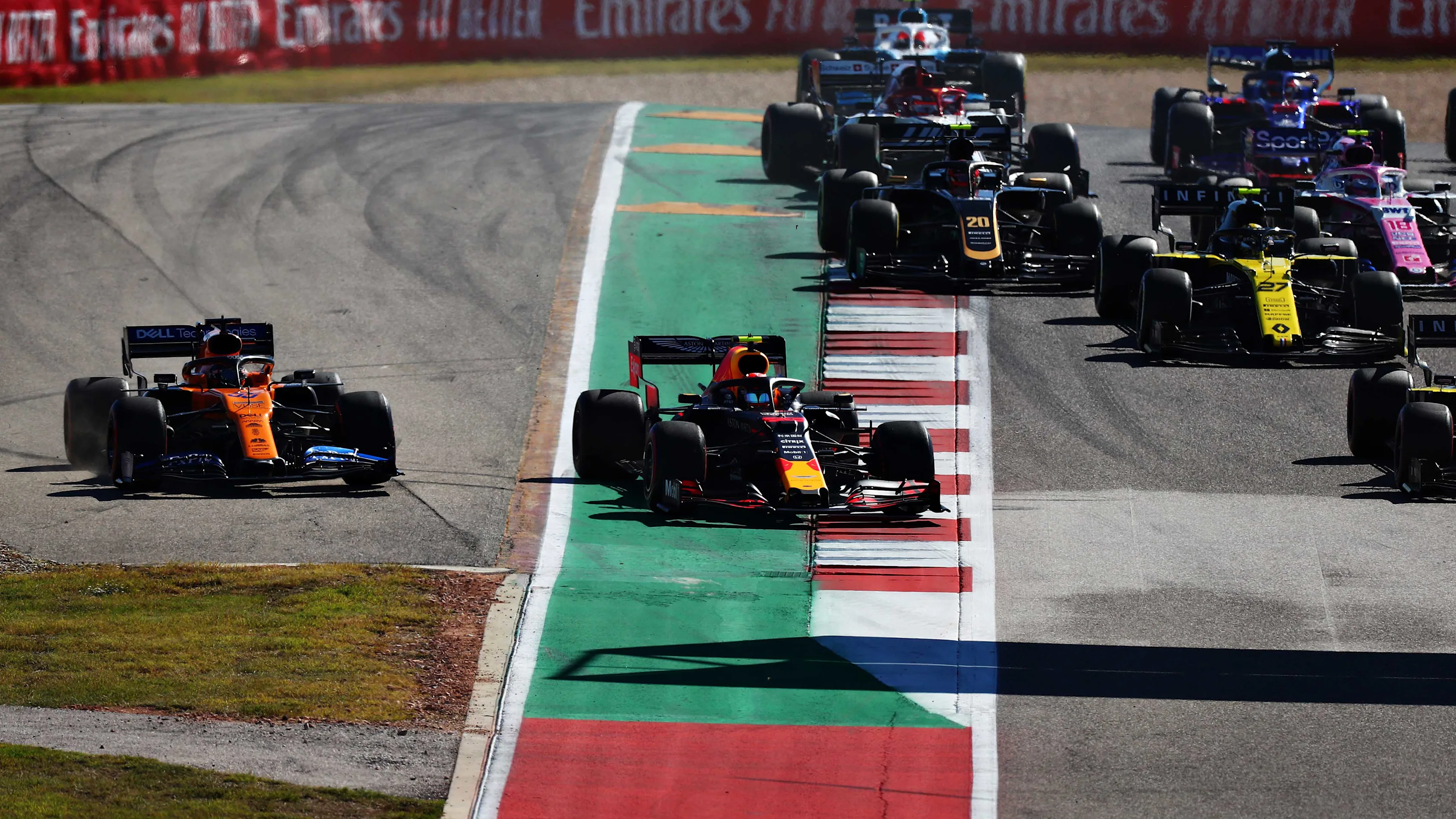 AUSTIN, TEXAS - NOVEMBER 03: Alexander Albon of Thailand driving the (23) Aston Martin Red Bull Racing RB15 and Carlos Sainz of Spain driving the (55) McLaren F1 Team MCL34 Renault battle for position at thestart during the F1 Grand Prix of USA at Circuit of The Americas on November 03, 2019 in Austin, Texas. (Photo by Dan Istitene/Getty Images)
