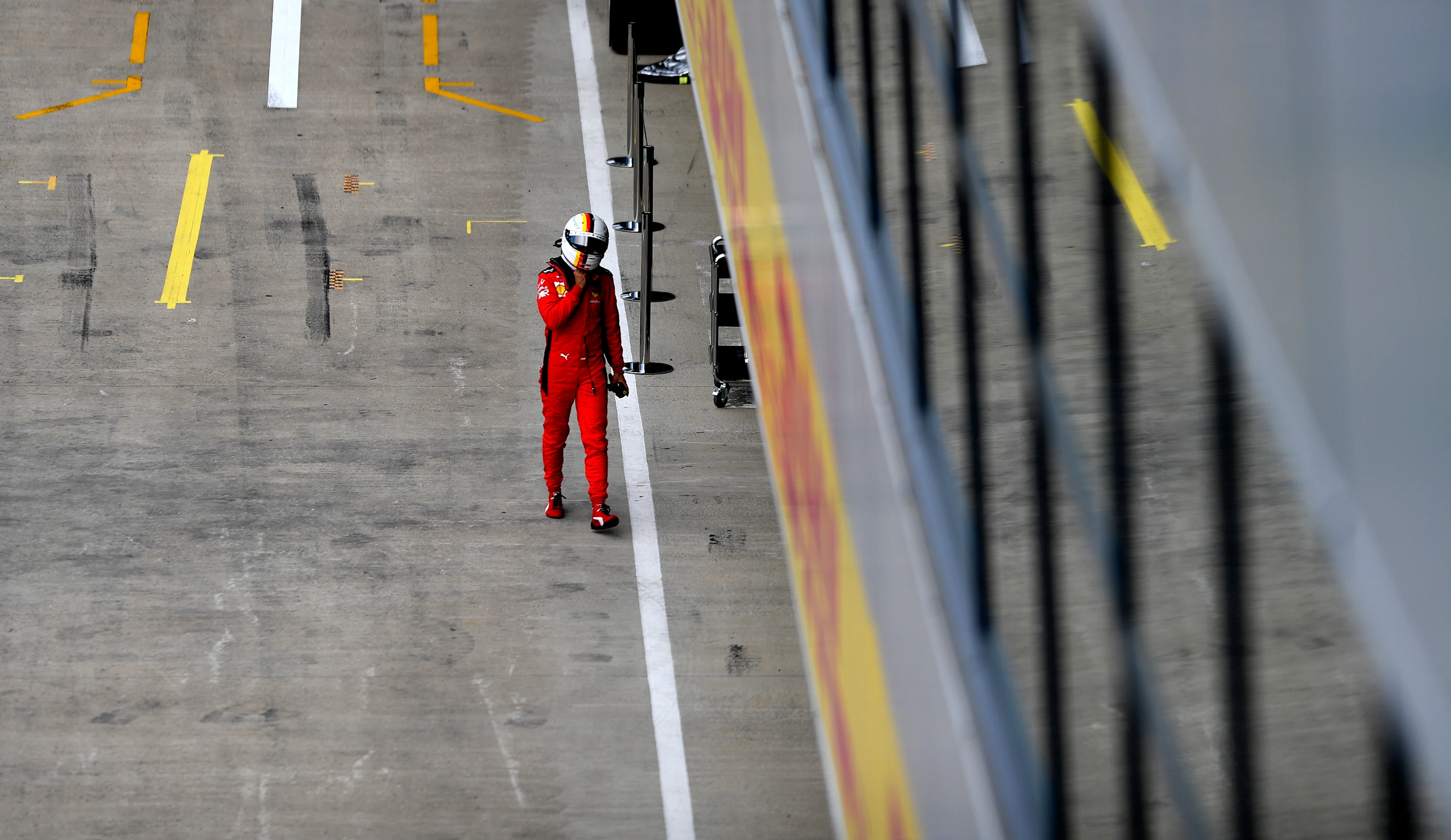 NORTHAMPTON, ENGLAND - AUGUST 08: Sebastian Vettel of Germany and Ferrari walks into the garage during qualifying for the F1 70th Anniversary Grand Prix at Silverstone on August 08, 2020 in Northampton, England. (Photo by Rudy Carezzevoli/Getty Images)